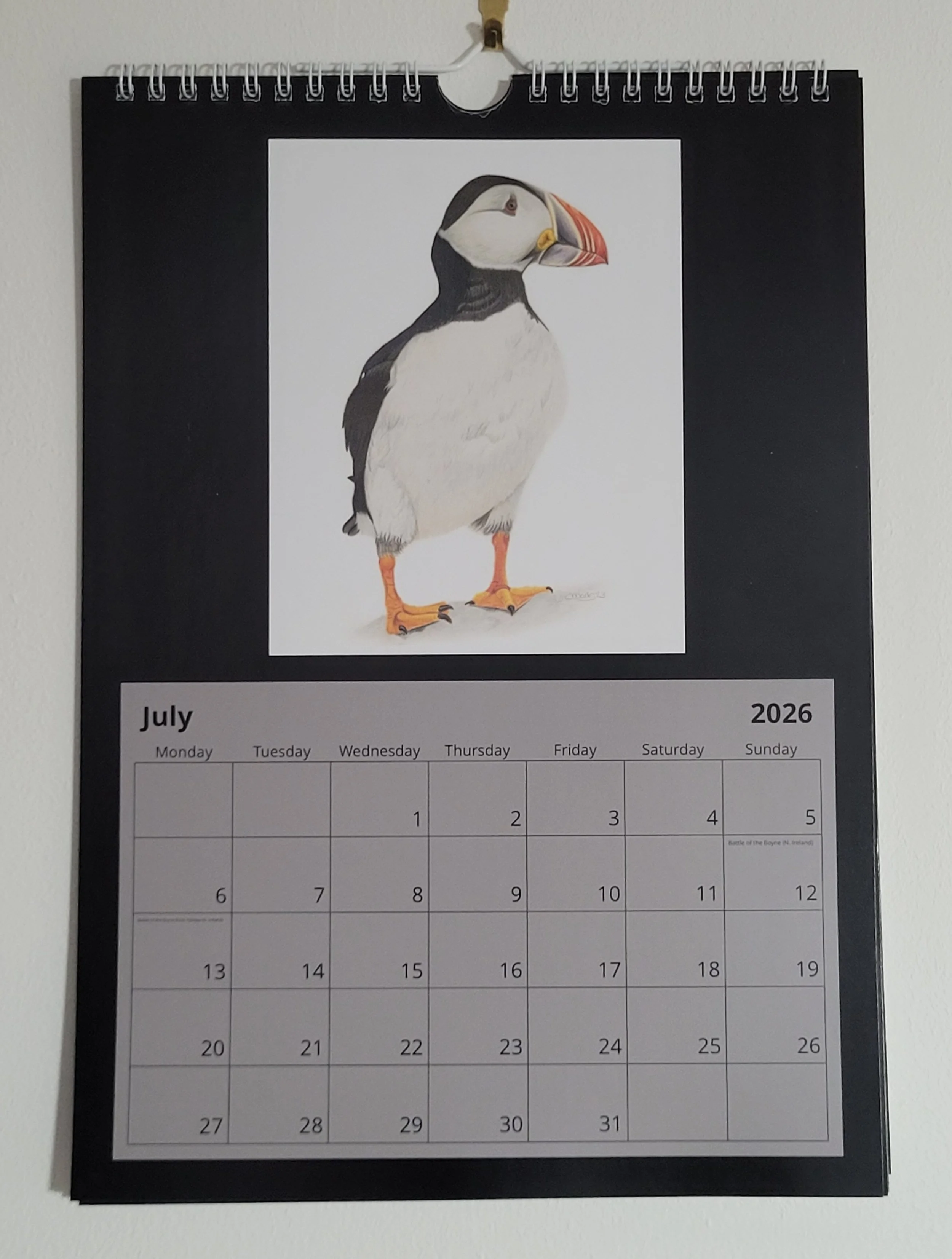 2026 wall calendar with British wildlife artwork. A puffin features for July.