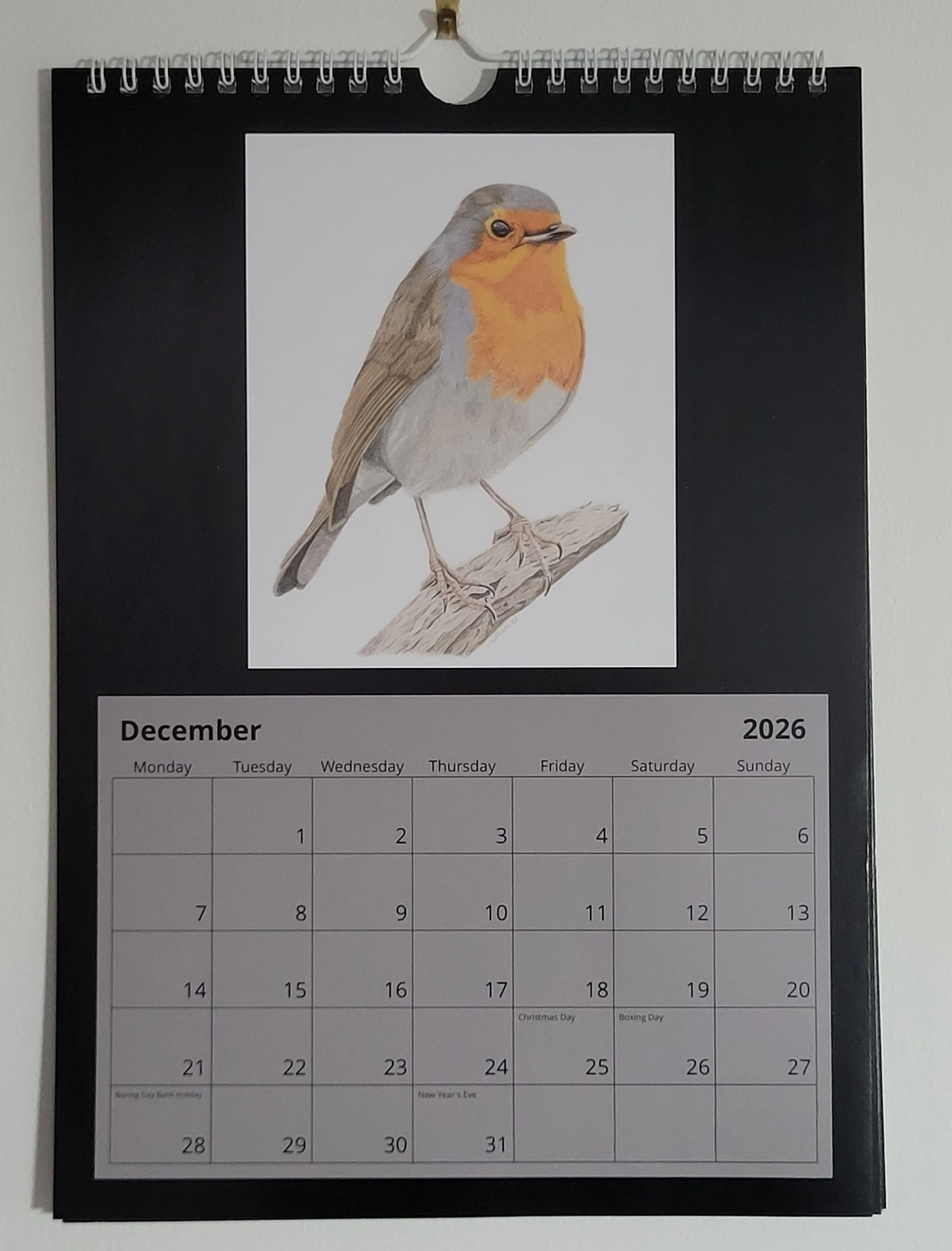 2026 wall calendar with British wildlife artwork. A robin is featured for December.
