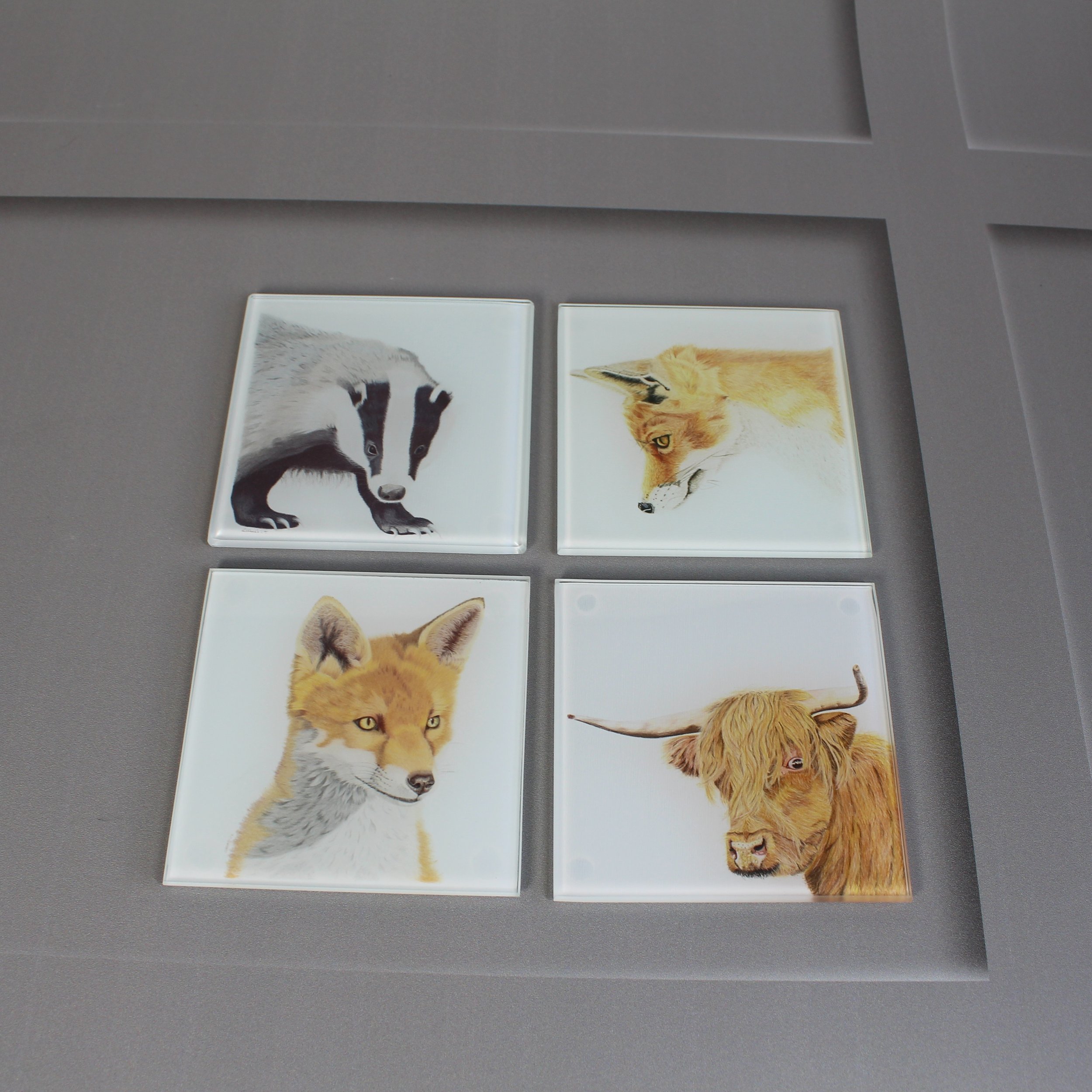 Gazing fox, badger and highland cow glass coasters.