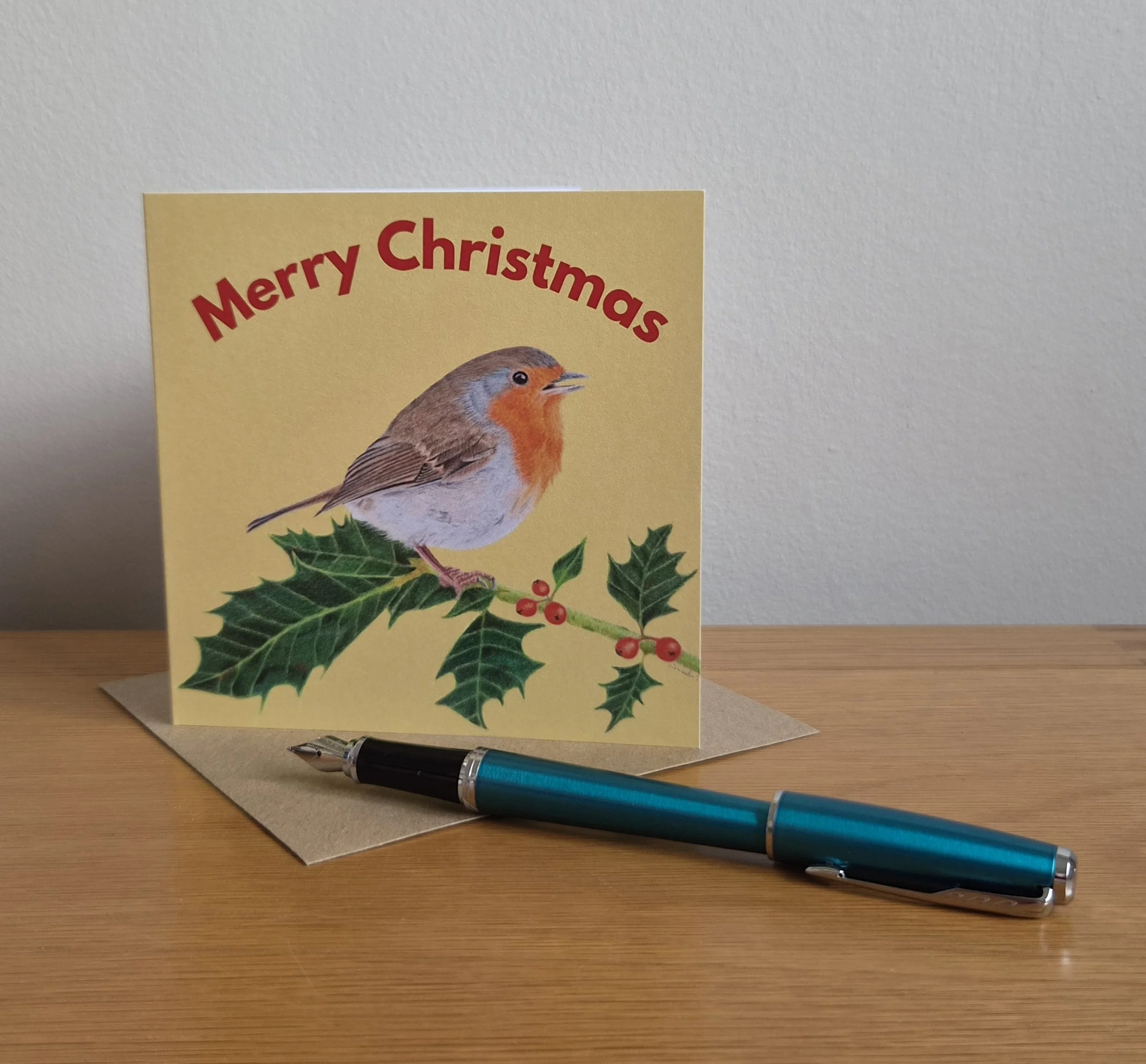 Robin on holly 'Merry Christmas' card with envelope (blank inside).