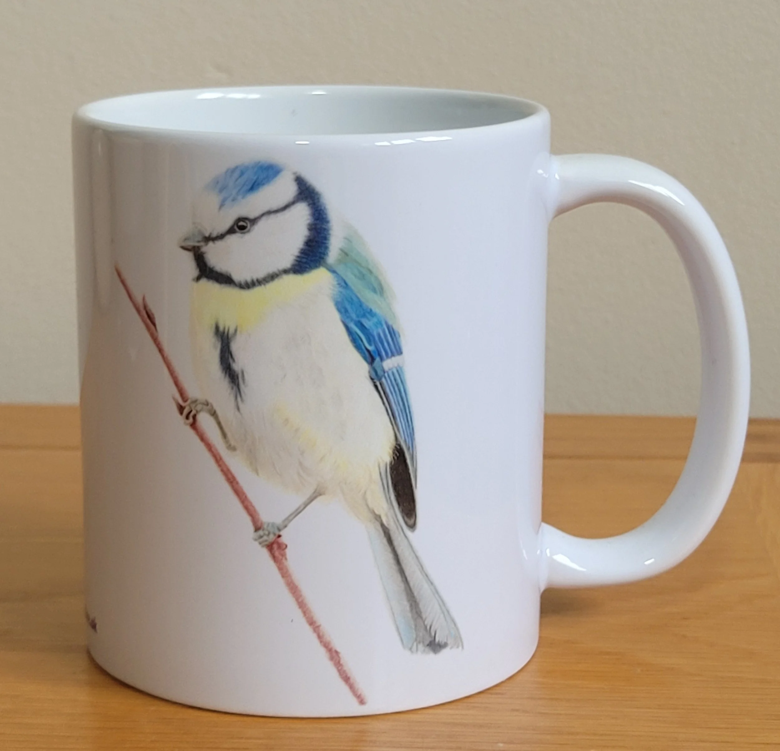 A blue tit white ceramic 11oz mug.