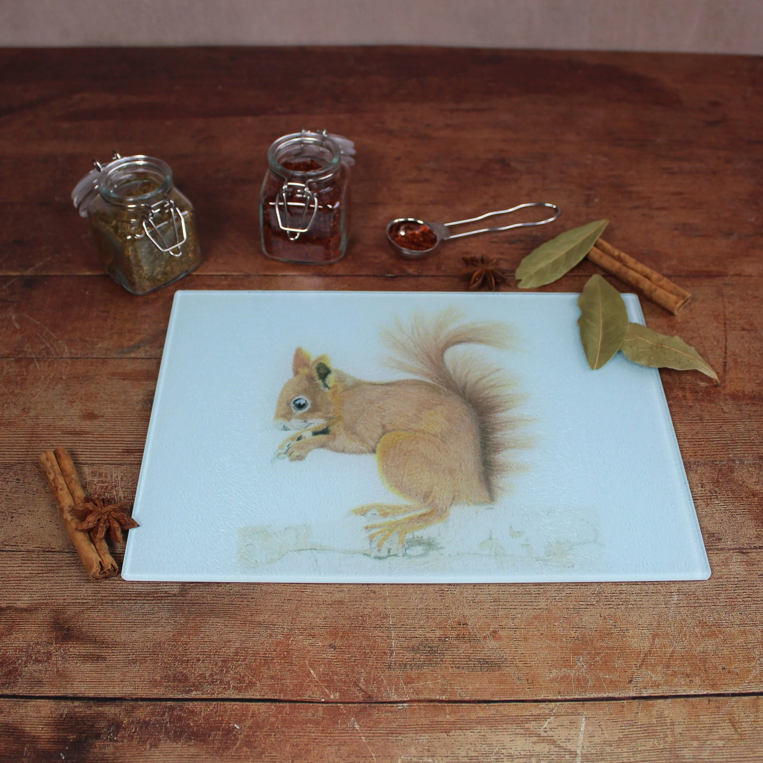 Red squirrel small glass chopping board / worktop saver.