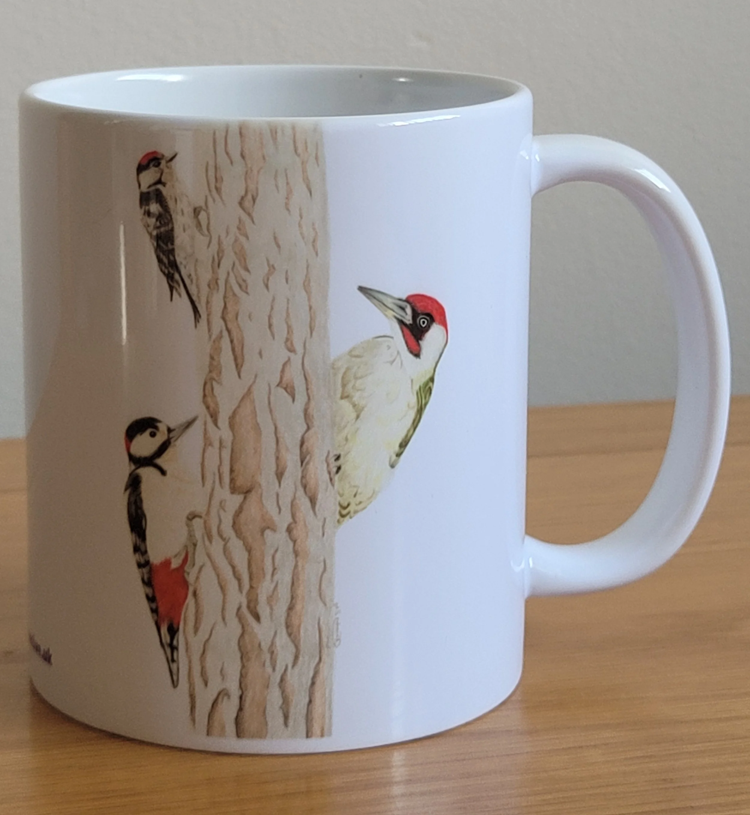 Woodpeckers mug featuring a green woodpecker, a great spotted woodpecker and a lesser spotted woodpecker.
