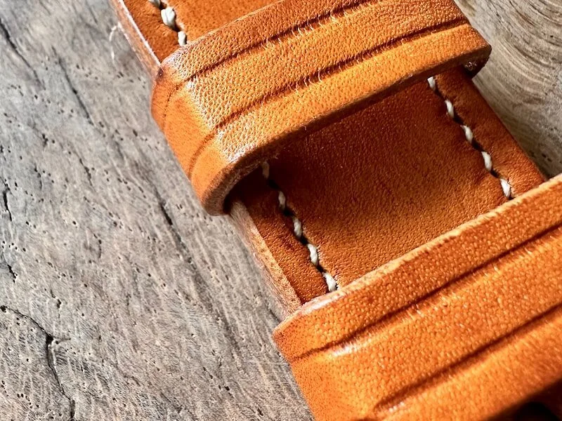 Aged oak bark leather belt showing natural patina from years of wear