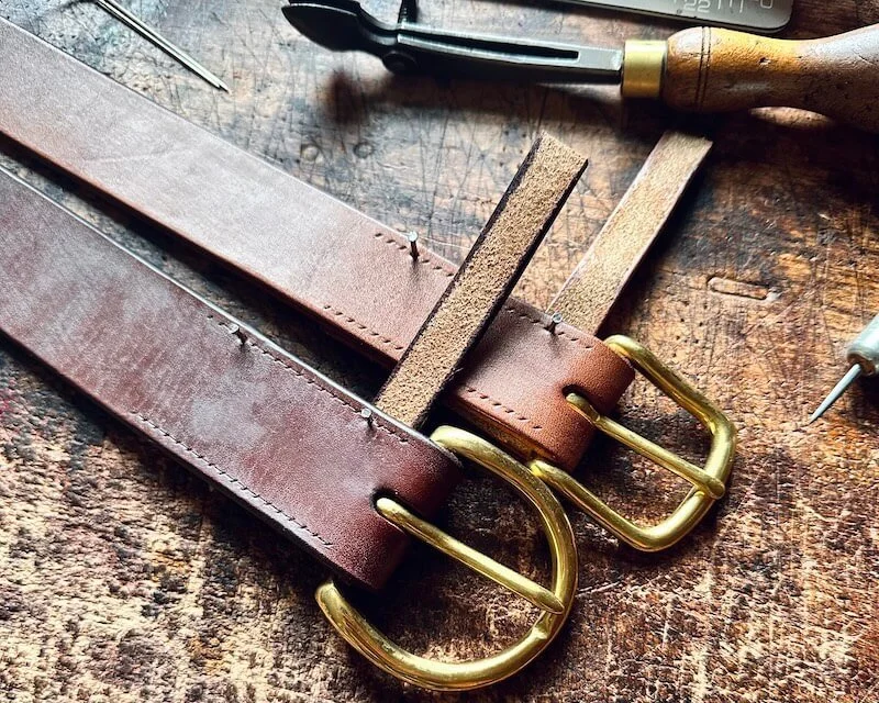British oak bark tanned bridle leather being cut for a handmade belt