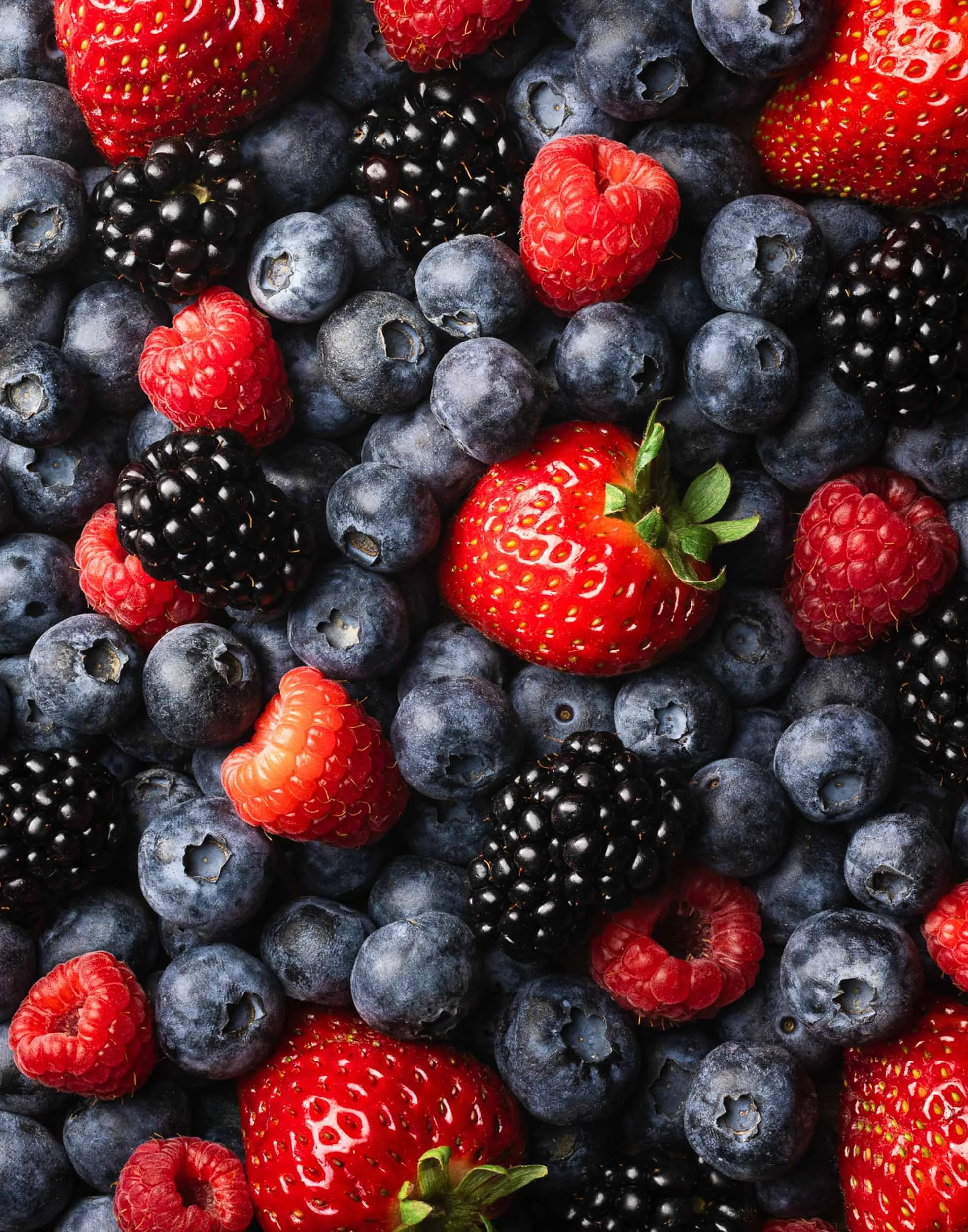 Mixed berry flatlay photography, professional fruit branding, overhead summer produce styling, organic blueberries strawberries and blackberries editorial, vibrant healthy food content for CPG marketing.