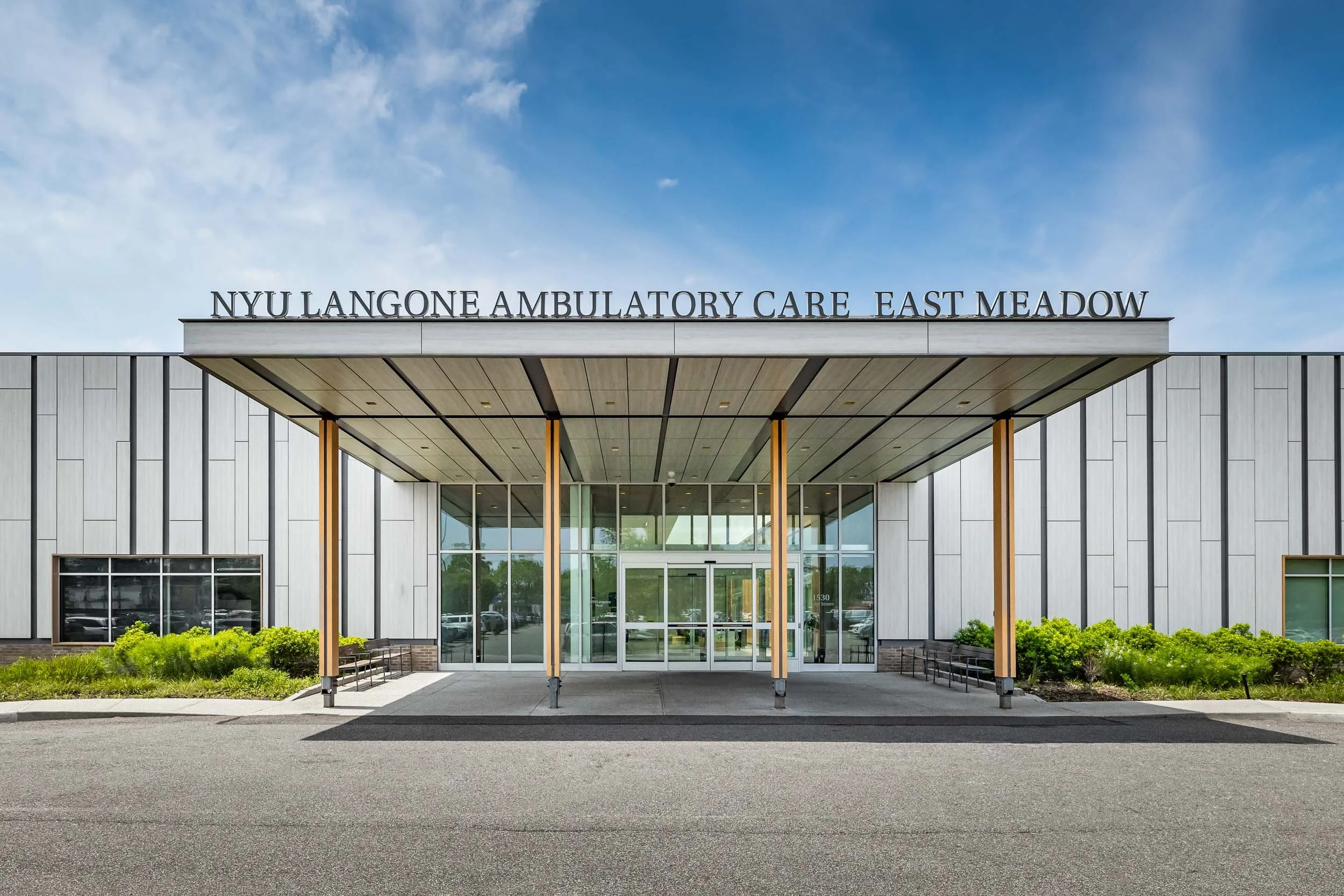 Institutional architecture photography, NYU Langone Ambulatory Care East Meadow exterior facade, professional commercial building photography, symmetrical medical facility entrance, modern healthcare architecture branding, architectural photography o