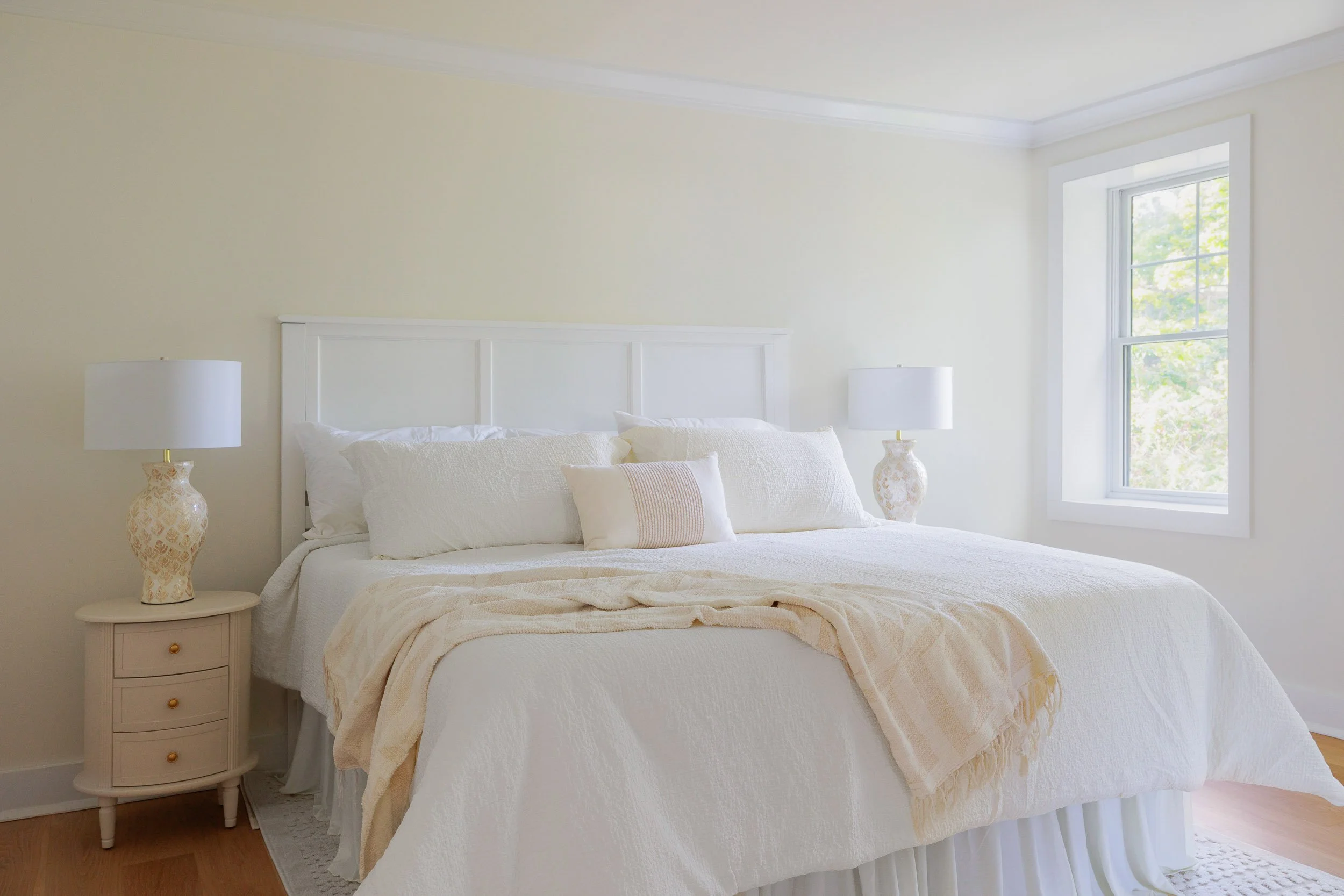 High-end bedroom interior photography, minimalist luxury suite design with neutral tones, professional architectural lighting for bright airy interiors, upscale residential bedroom styling, clean lines and natural light in interior architecture.