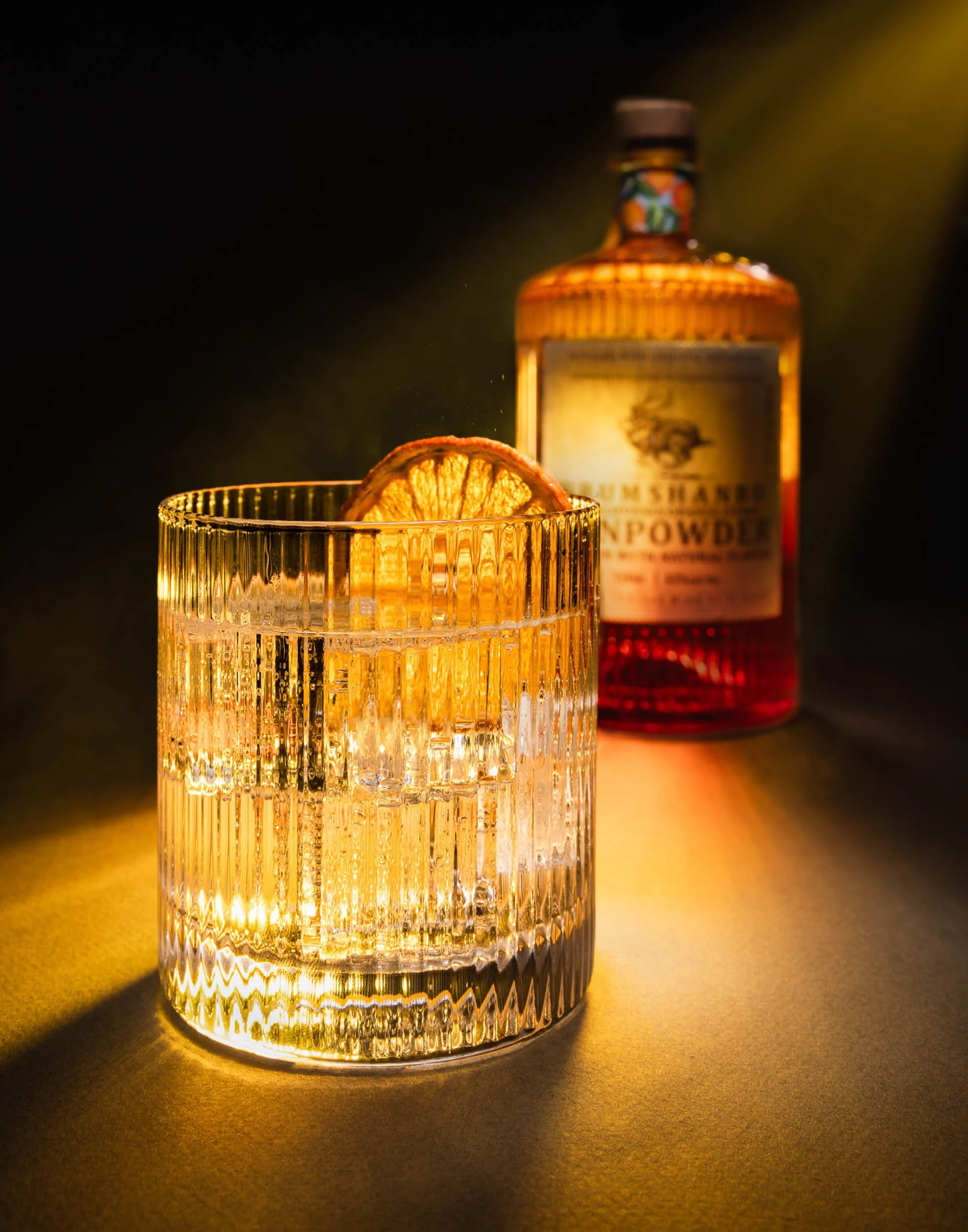 Drumshanbo Sardinian Citrus Gin product photography, professional orange gin bottle branding, luxury spirits advertising with light caustics and refraction, botanical citrus gin cocktail imagery, high-end Irish gin product shot, technical optical dis