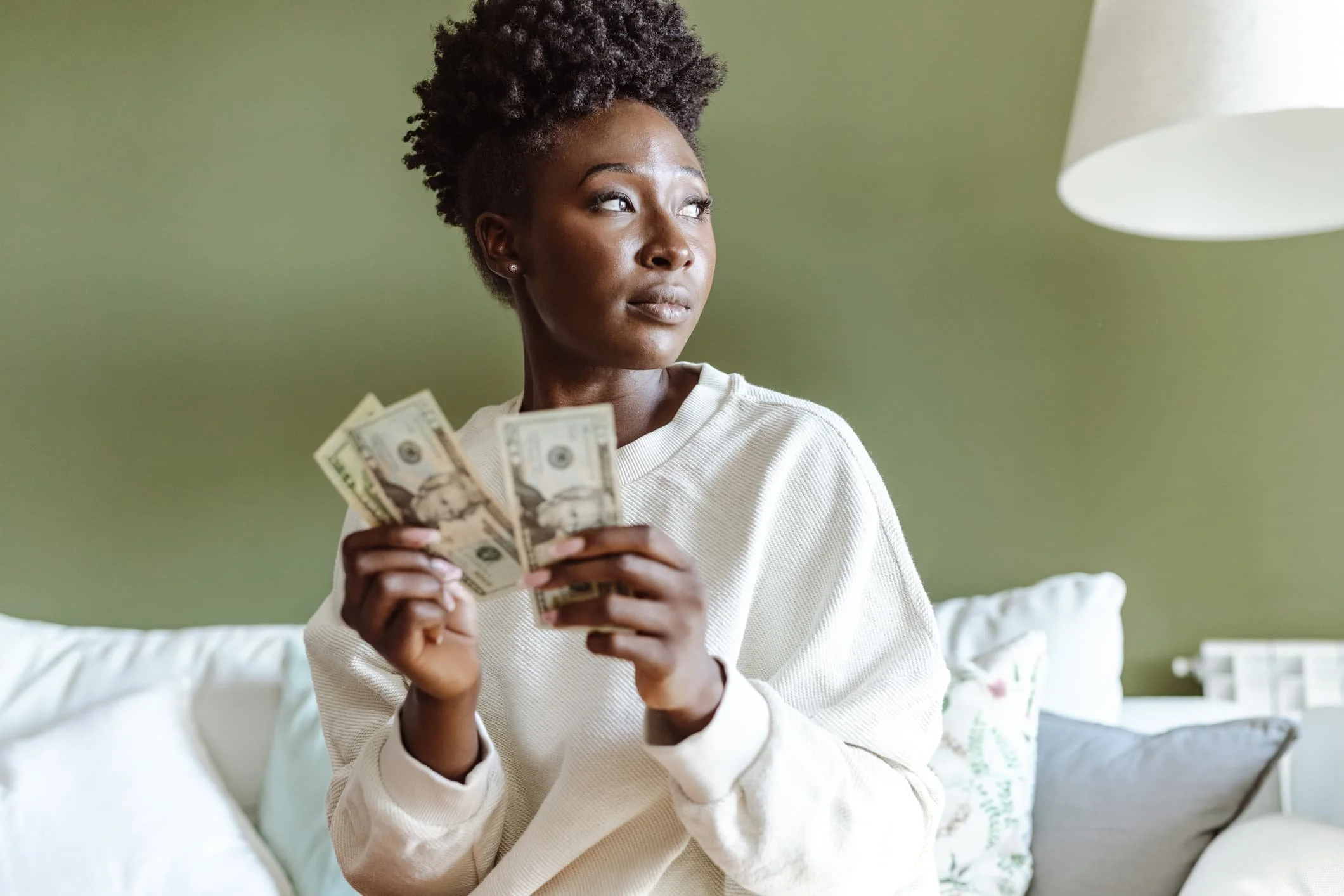 Woman managing home finances with The Brands + Bands Strategy Group