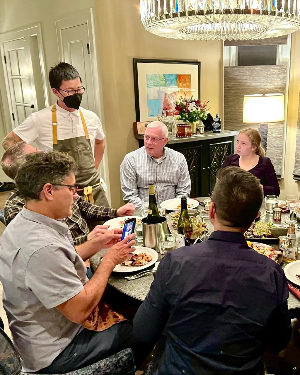 Private chef hosting a seated dinner party in a Saratoga Springs, NY home - Mise En Place culinary team with guests enjoying in-home fine dining experience