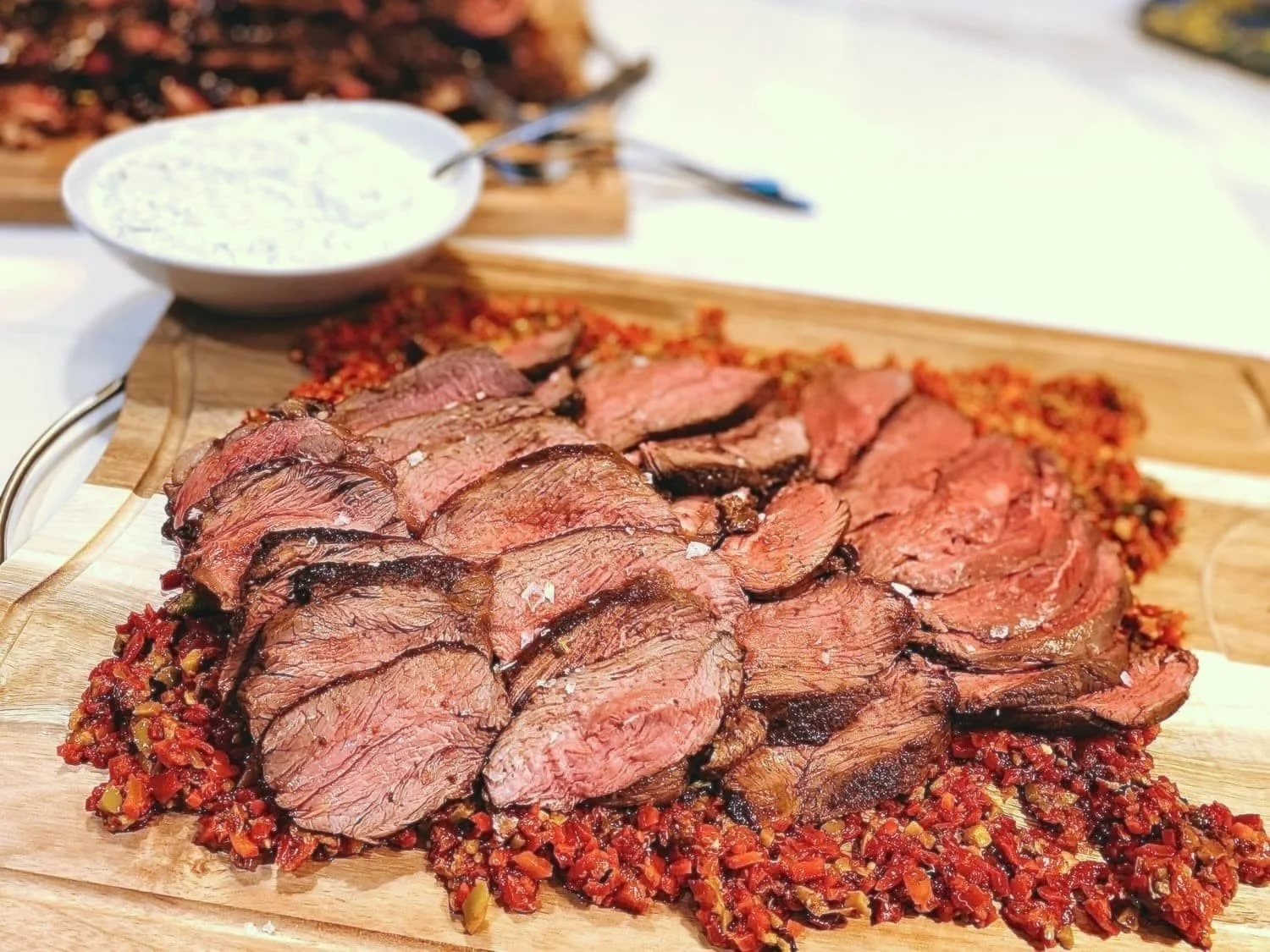 Elevated barbeque having lamb loin and piquillo peppers in Woodside, CA