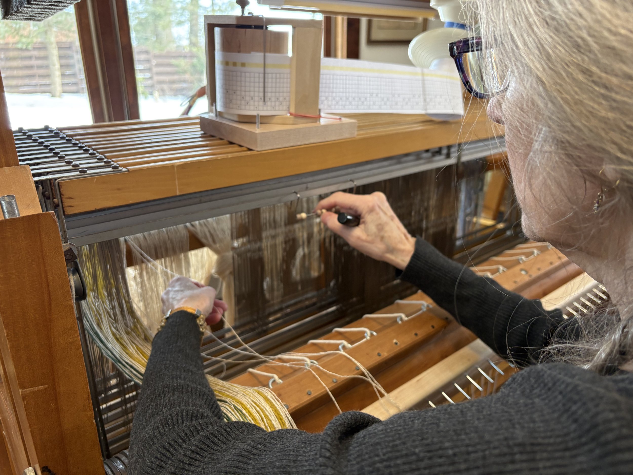 Weaver moving the bead on an abacus