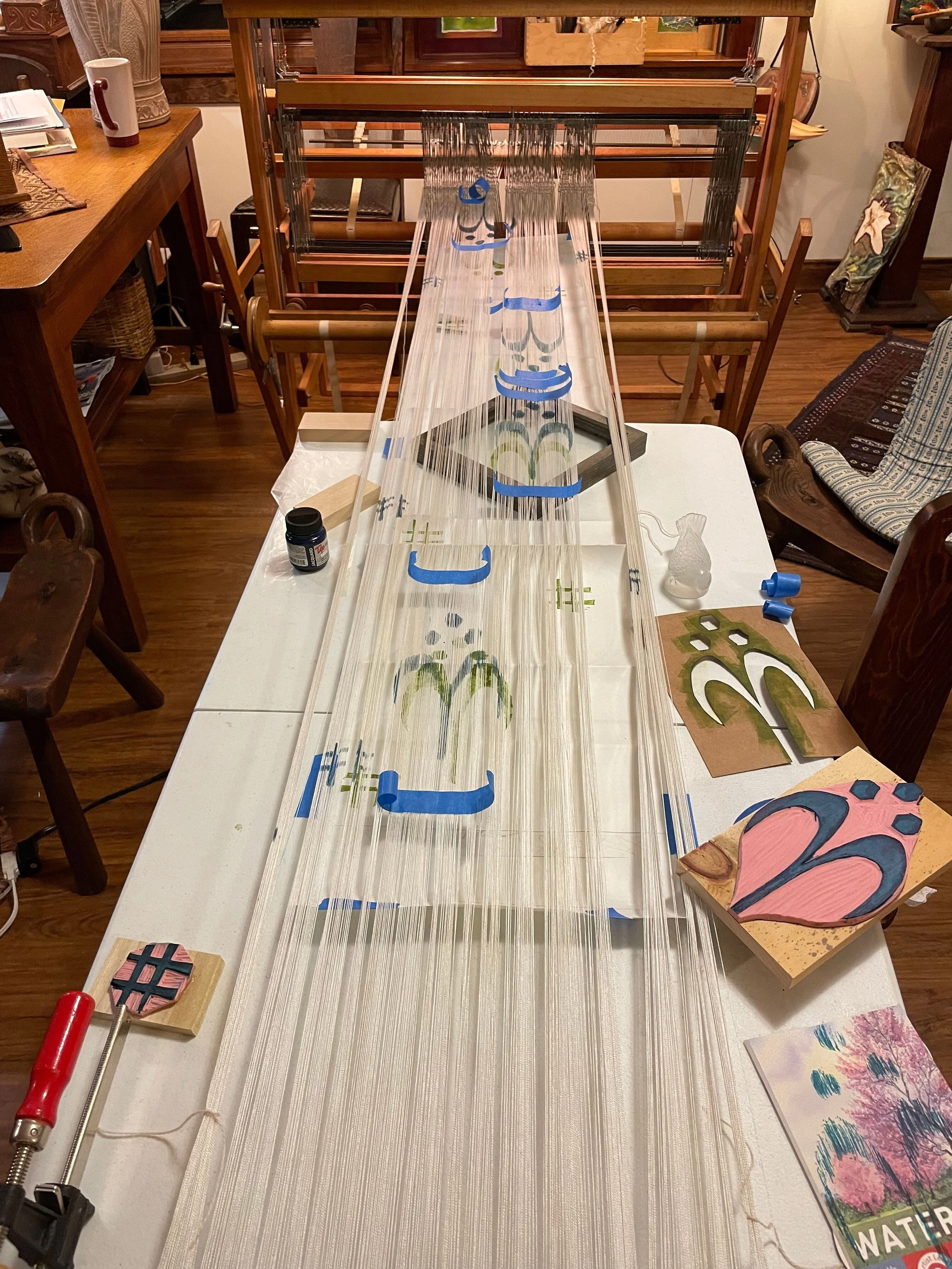 loom with warp threads stretched out on a table for painting