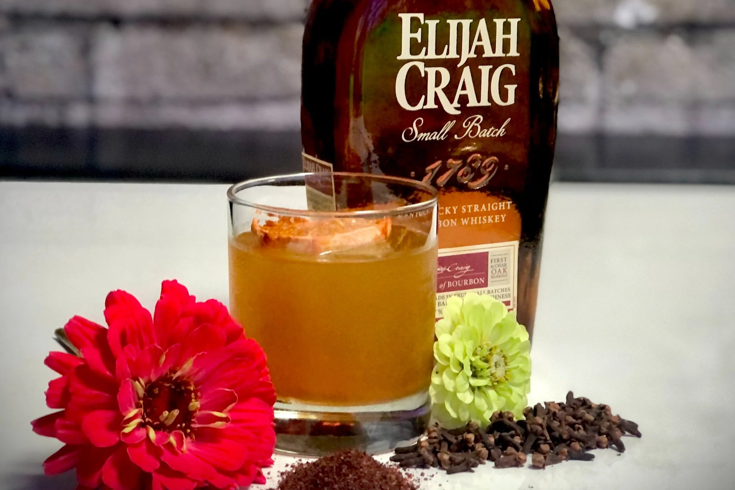 From above hands of unrecognizable woman rubbing aromatic spices into piece of raw meat over parchment paper