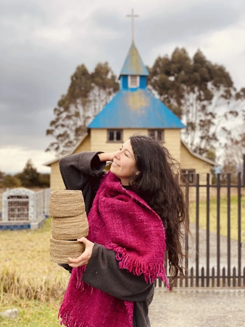 artist holding baskets.jpg