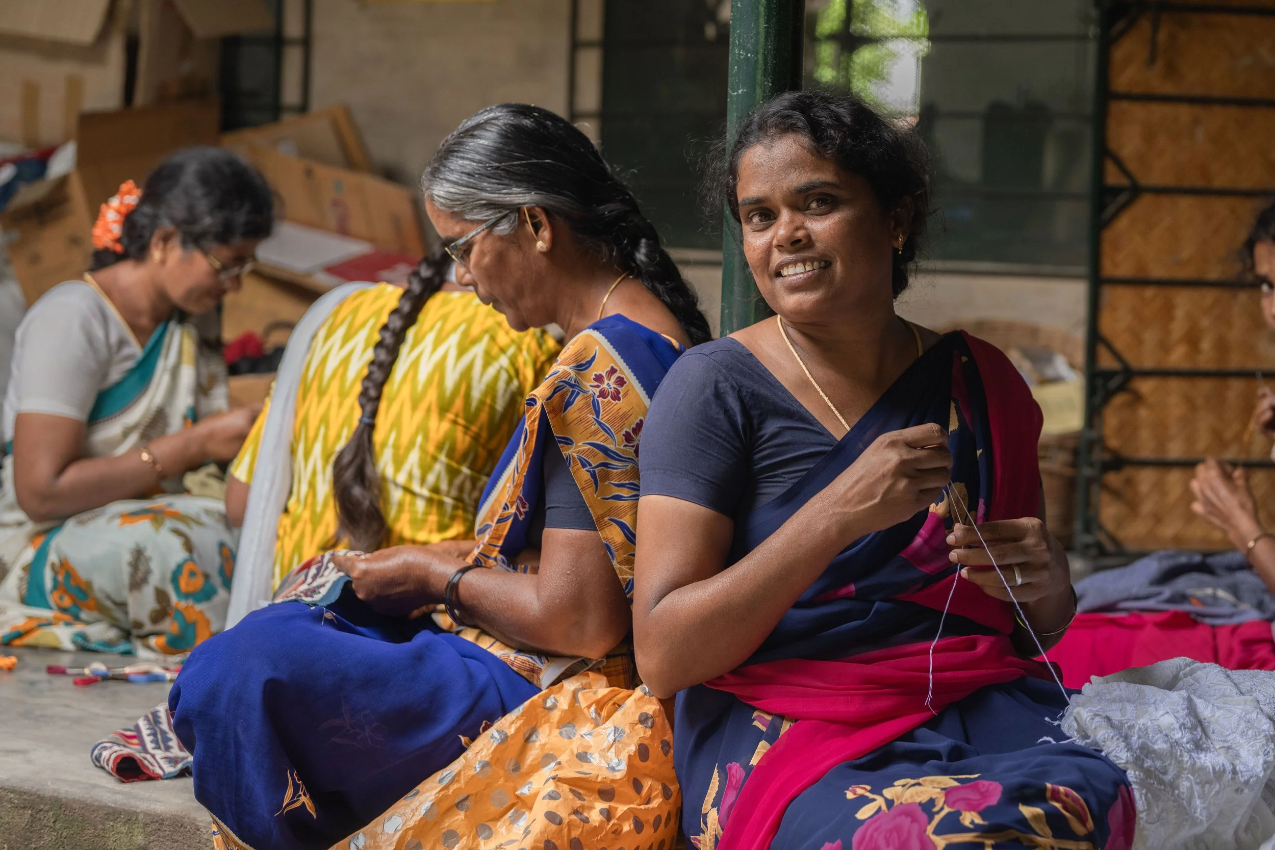 Indian women in traditional dress sewing