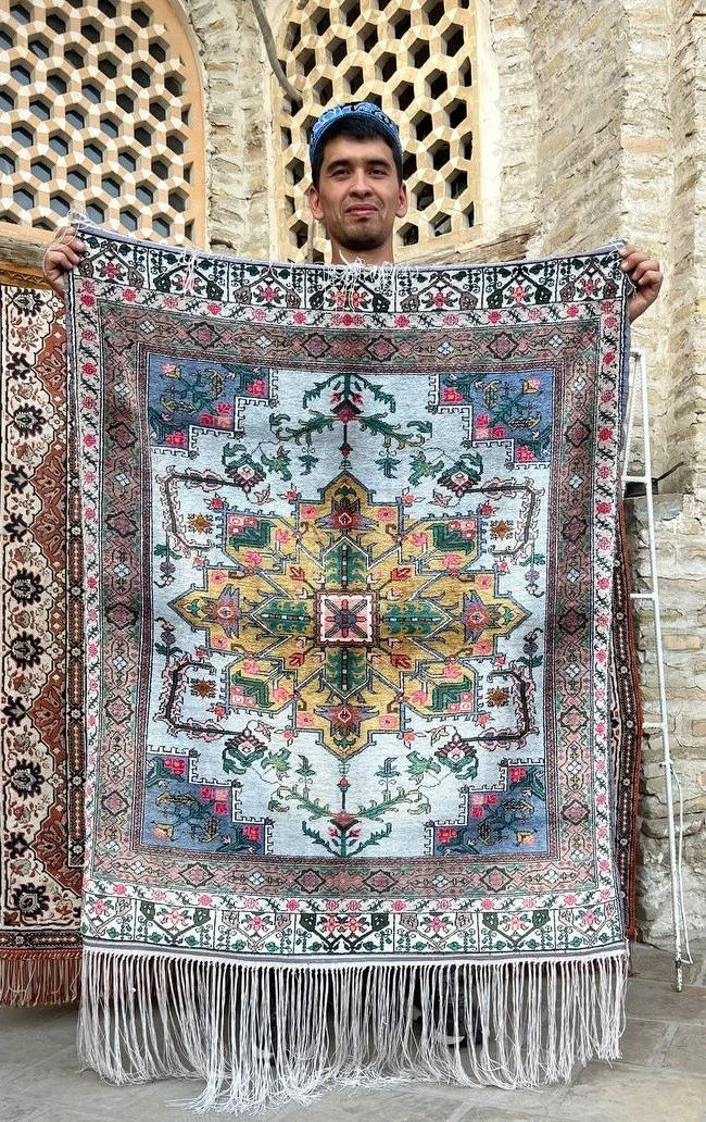 artist holding rug