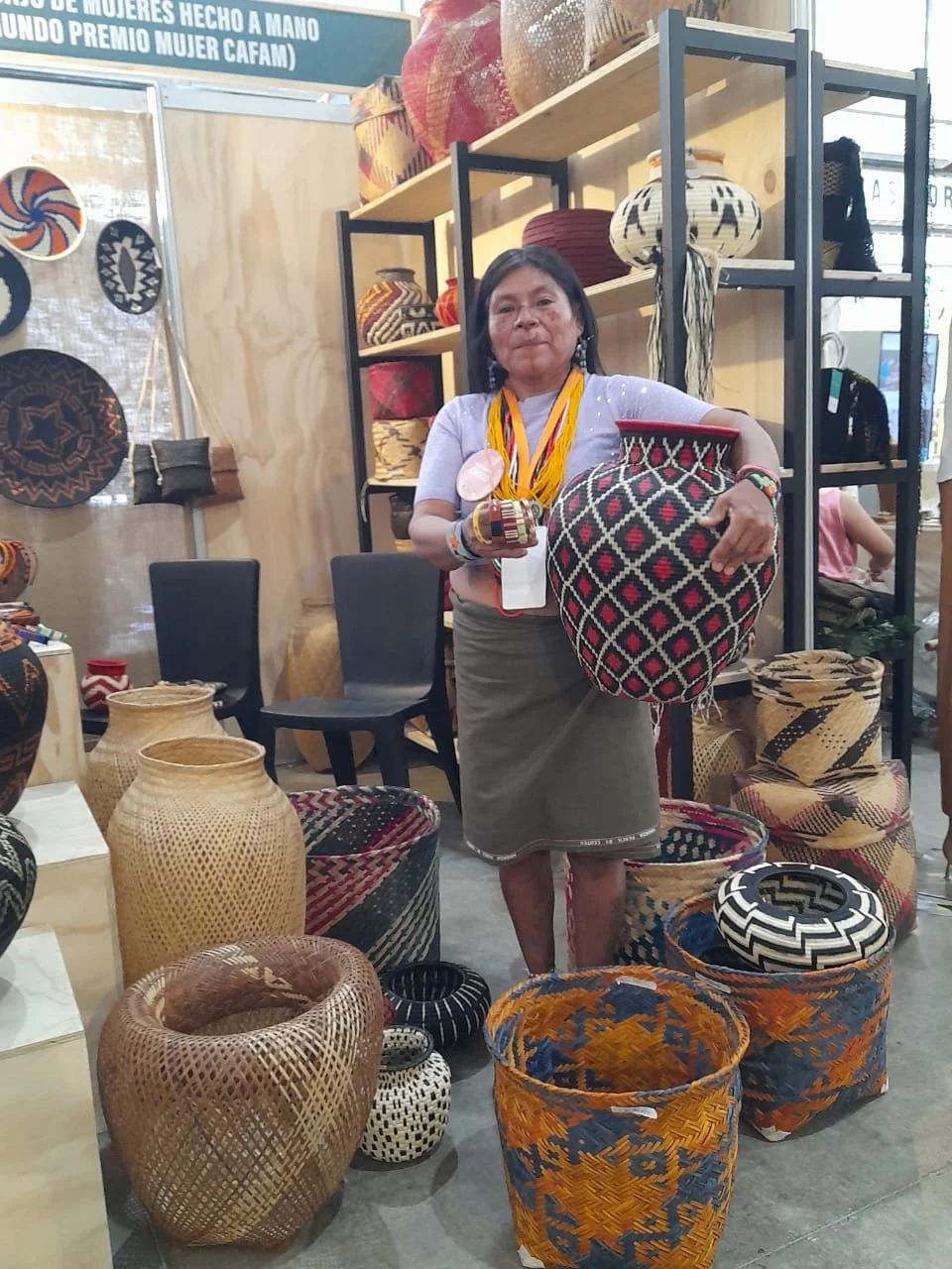 Artist Jenny Cardenas with baskets and other products