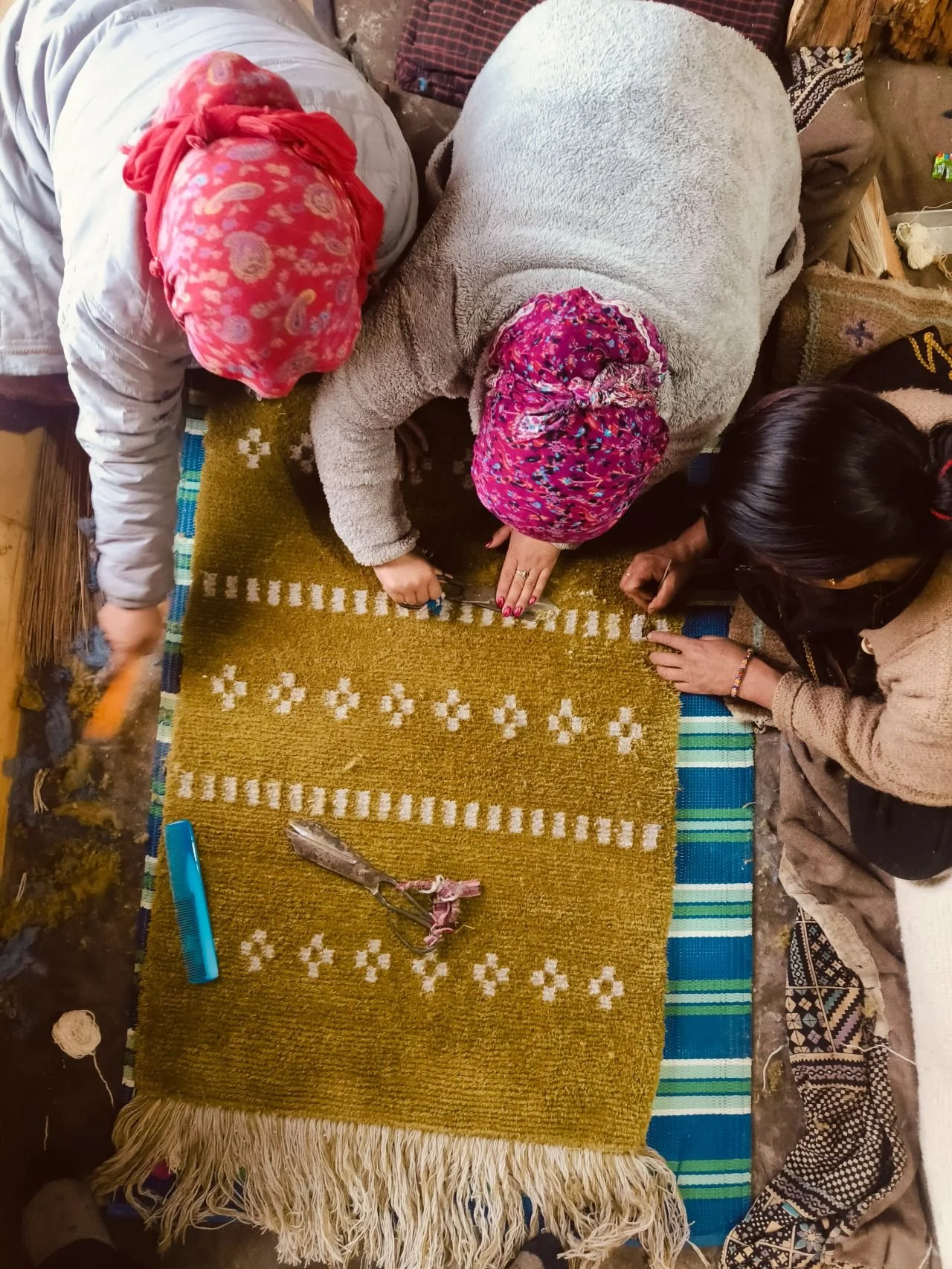 women working on a rug