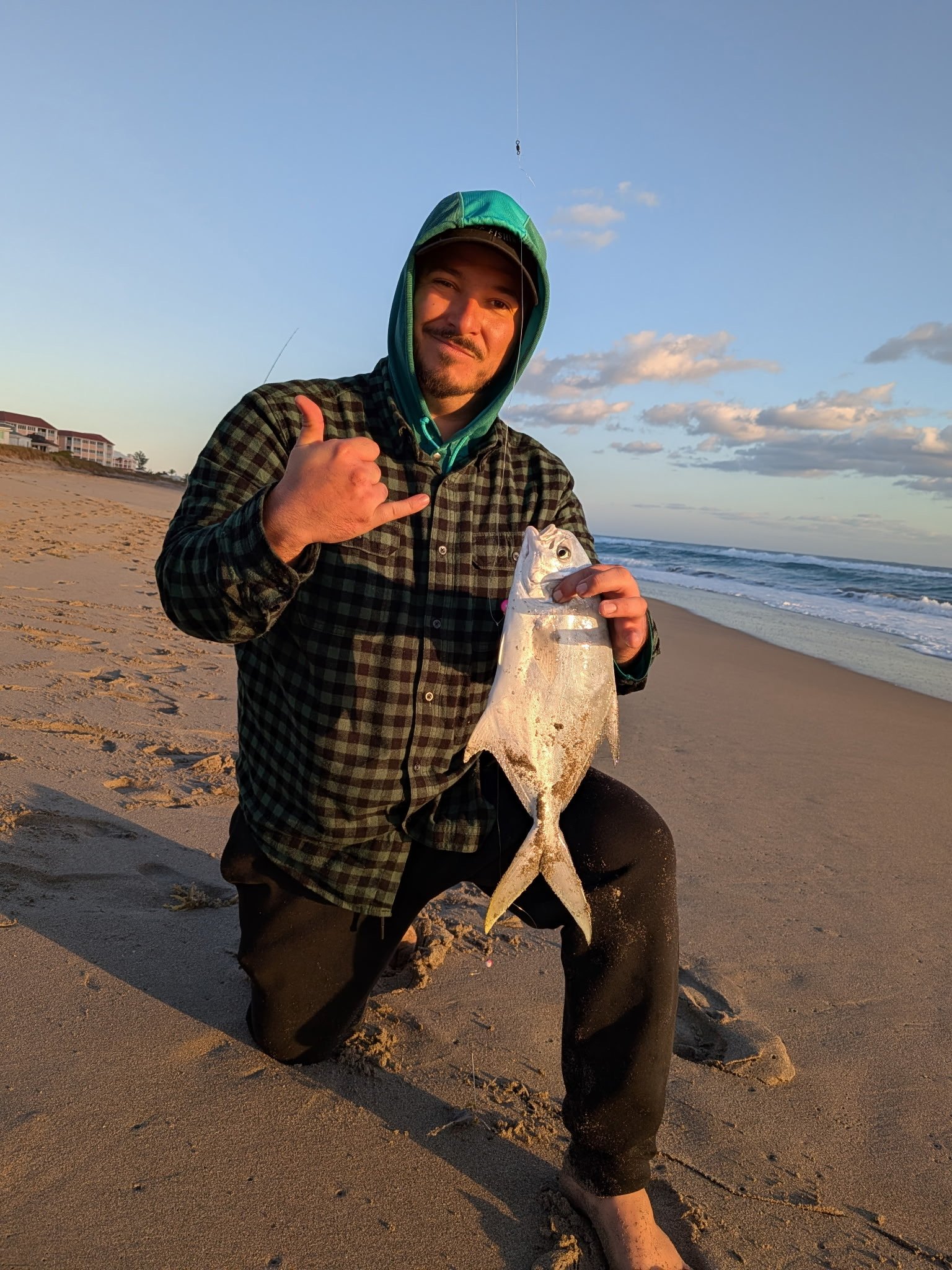 Guide Matt Nieves holding a pompano caught surf fishing on Florida's Space Coast