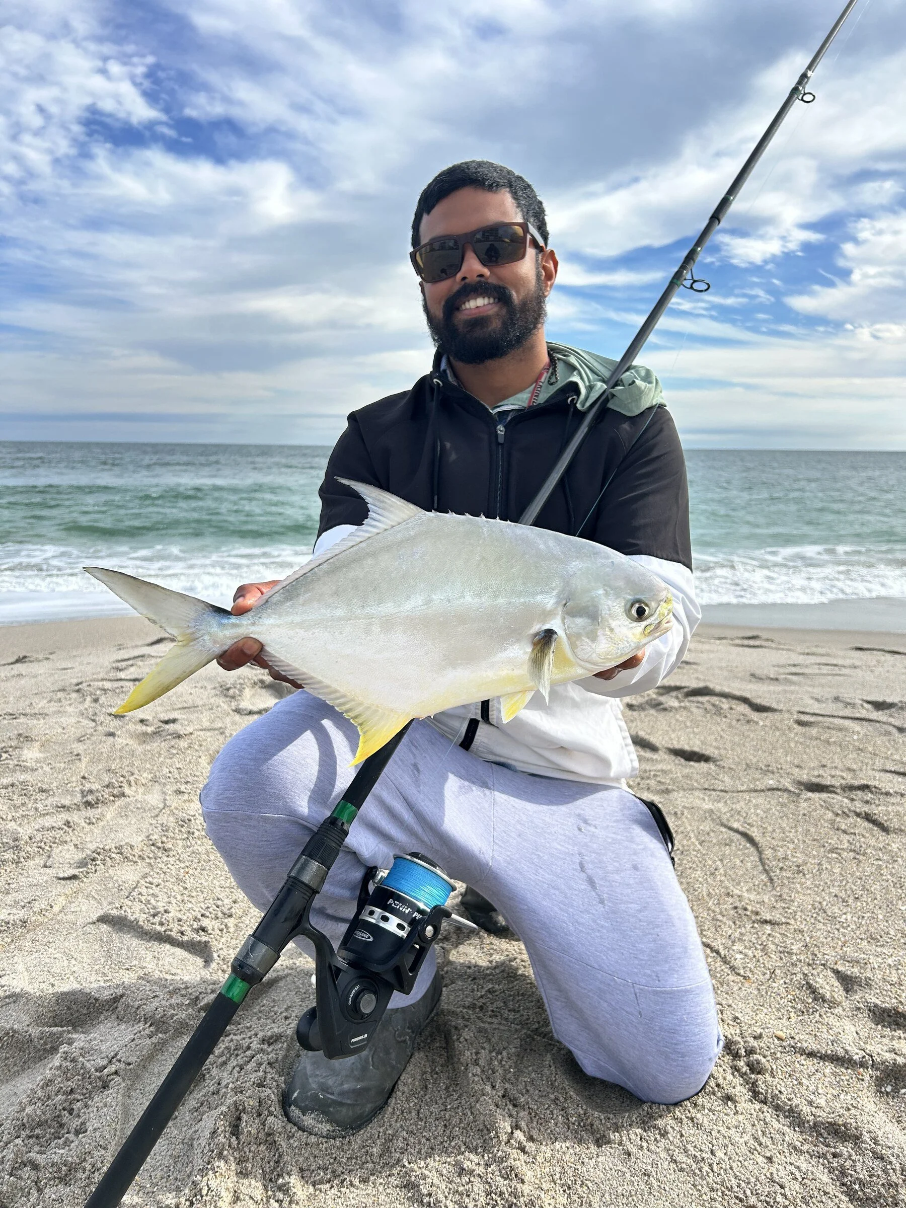 Captain Shasta "Rio" Sirju holding a pompano caught surf fishing on Florida's Space Coast