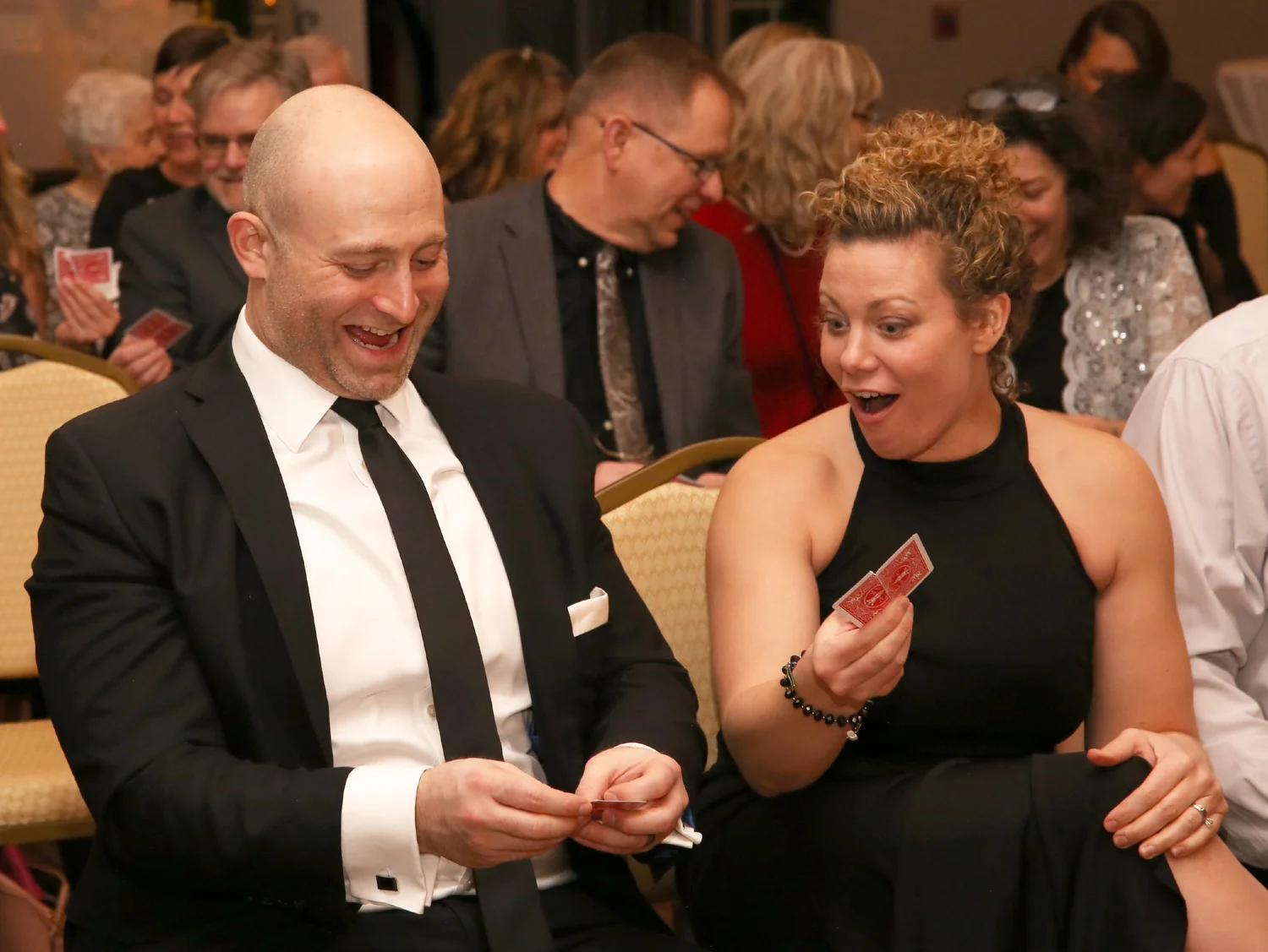 A fundraiser audience watching a magic show