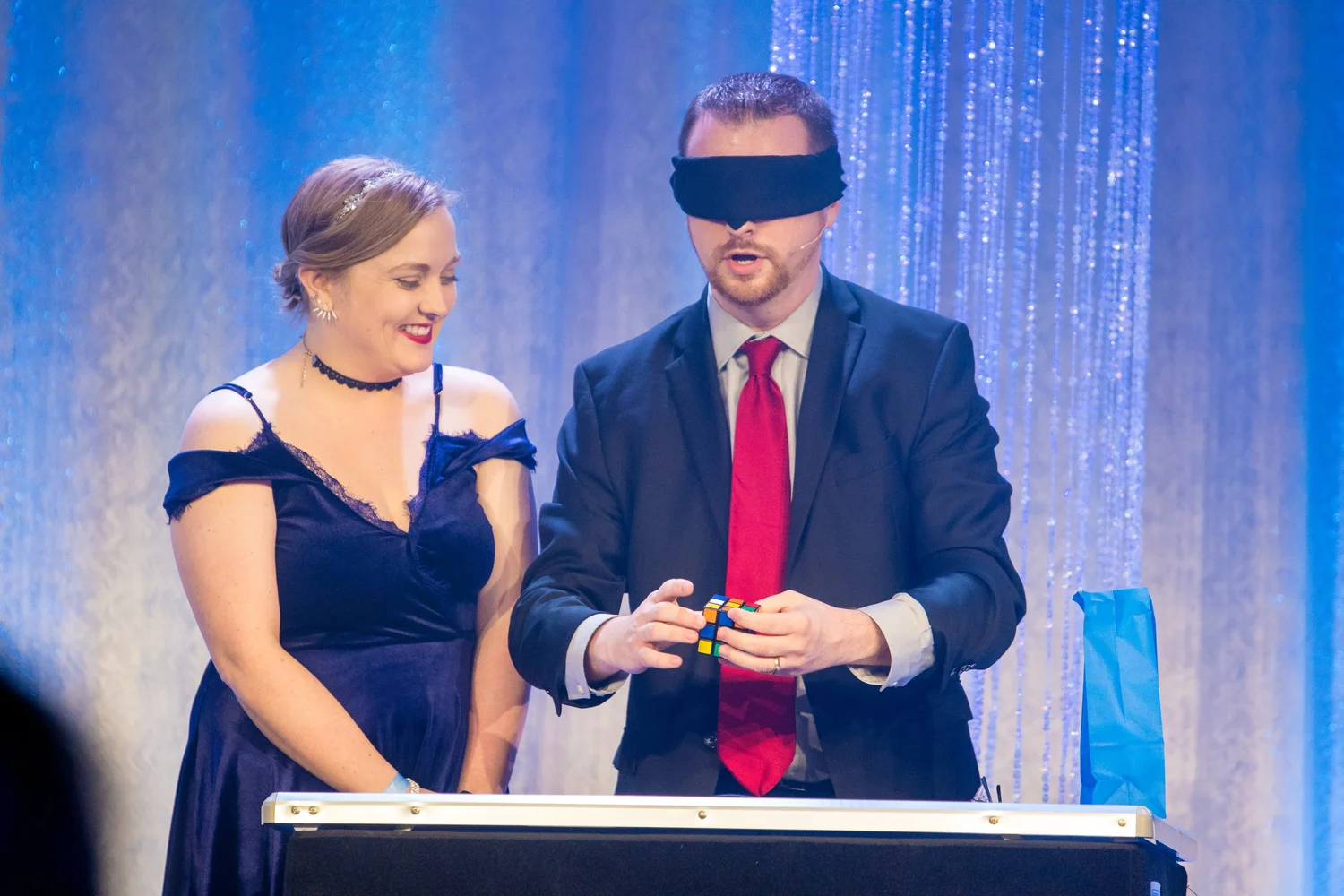 Caleb solving a puzzle cube blindfolded on stage