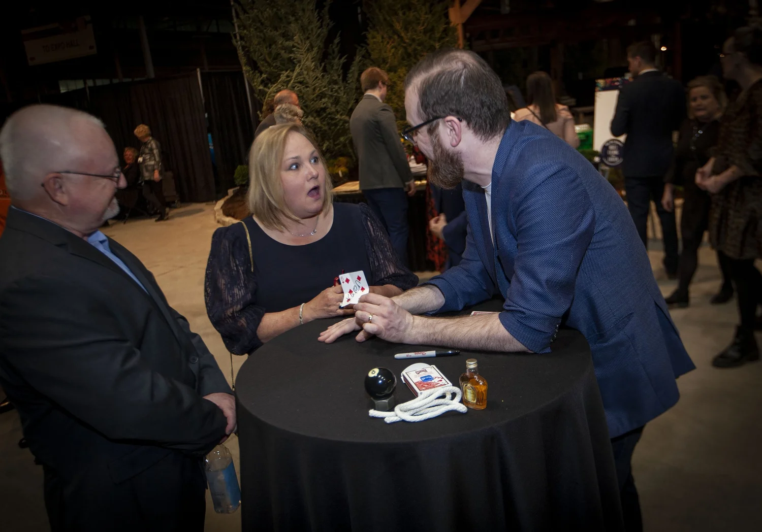 Guests reacting to cards spread across a table
