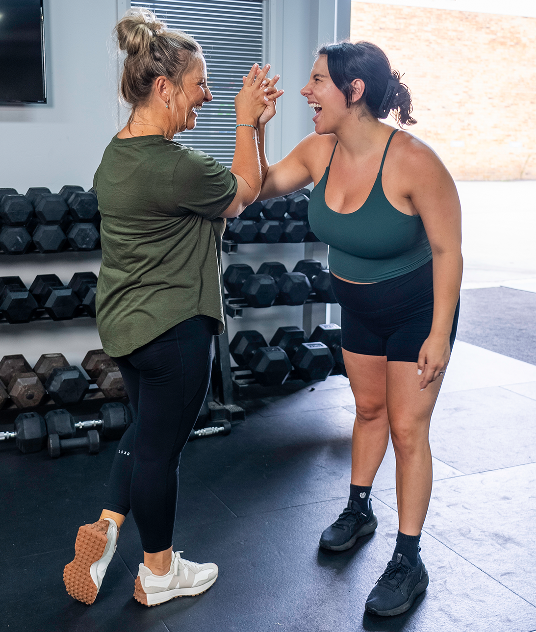 HERPhase Emma Scrench High Fiving Client In Gym Smiling