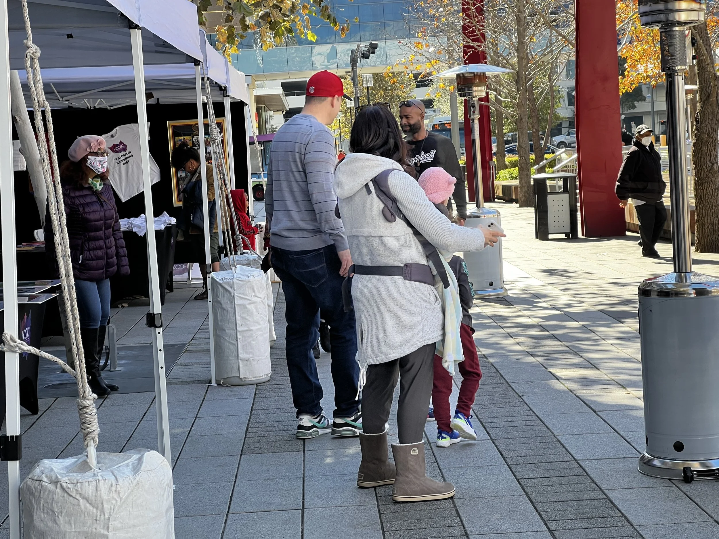 Local downtown residents enjoy black art from the festival.