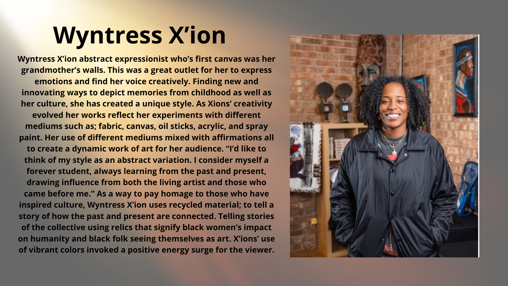 A text detailing Wyntress X'ion's journey as an abstract expressionist artist, using various mediums to explore cultural and personal themes. The artist is pictured standing in an art studio with a smile, wearing a black jacket. The studio features artwork and cultural objects on the walls.