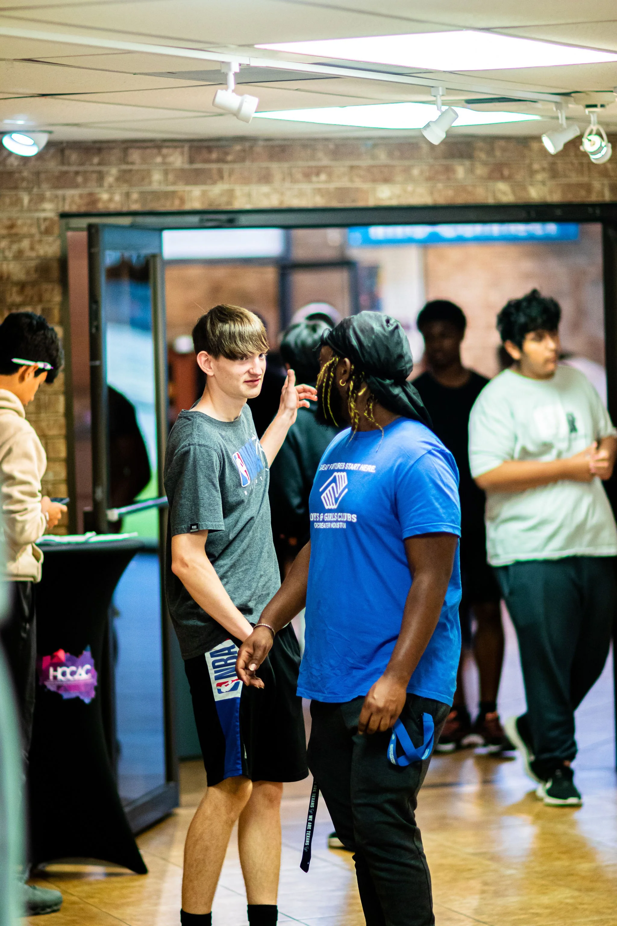 Boys interacting with each other in gallery.