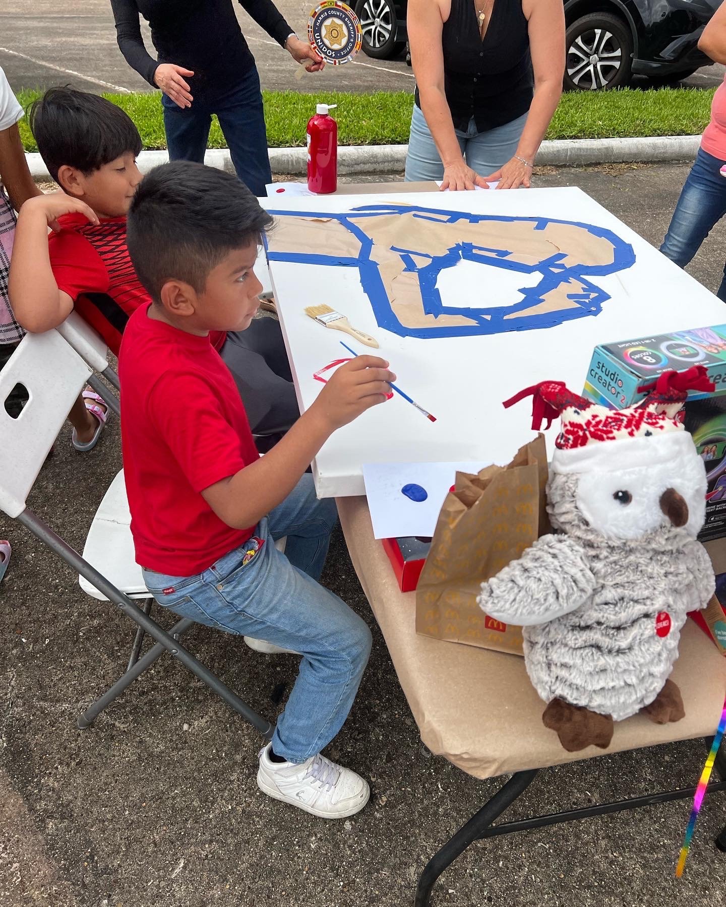 Kids painting on featured artists unfinished painting 