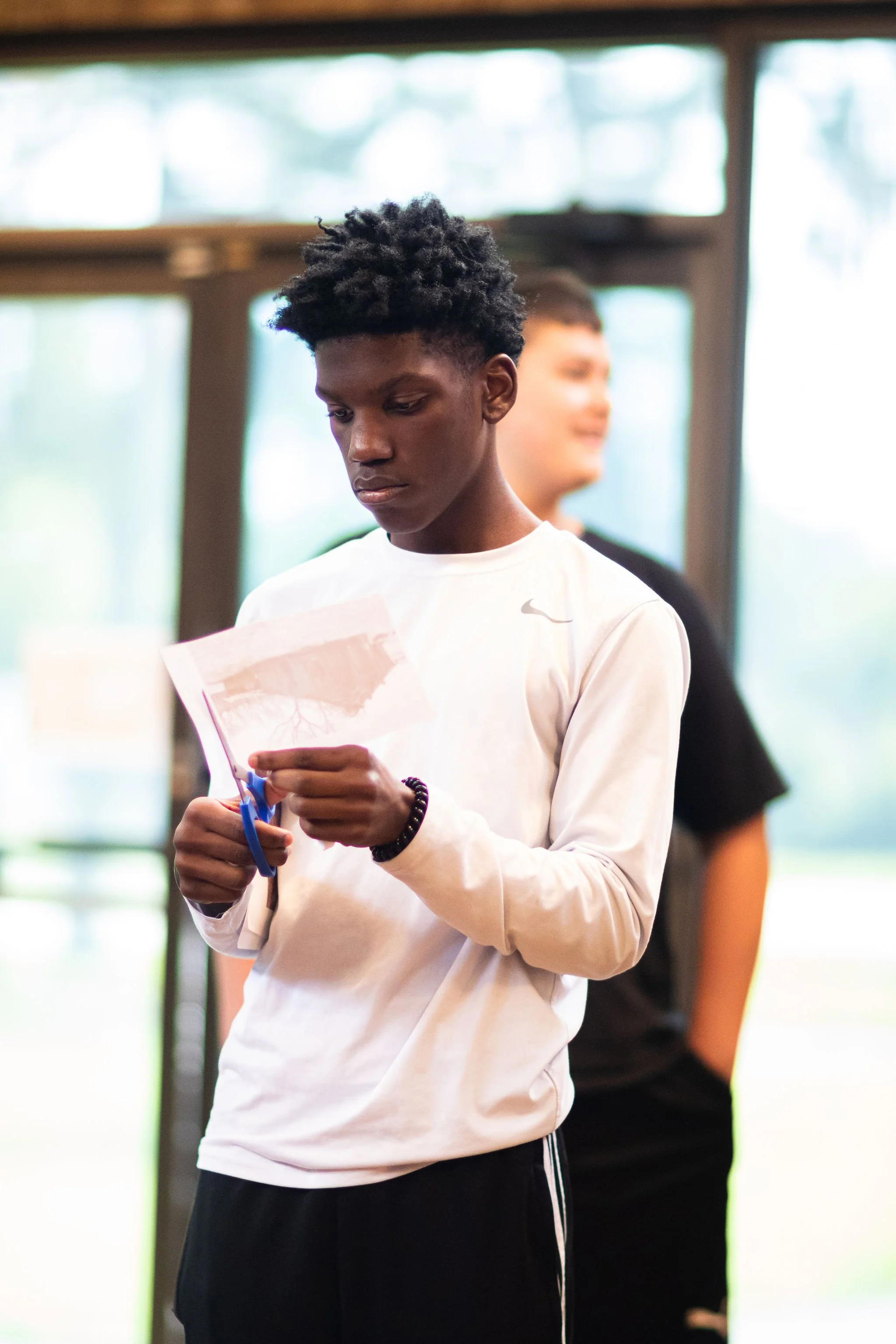 Student participating in Aesthetic inheritances collage making.