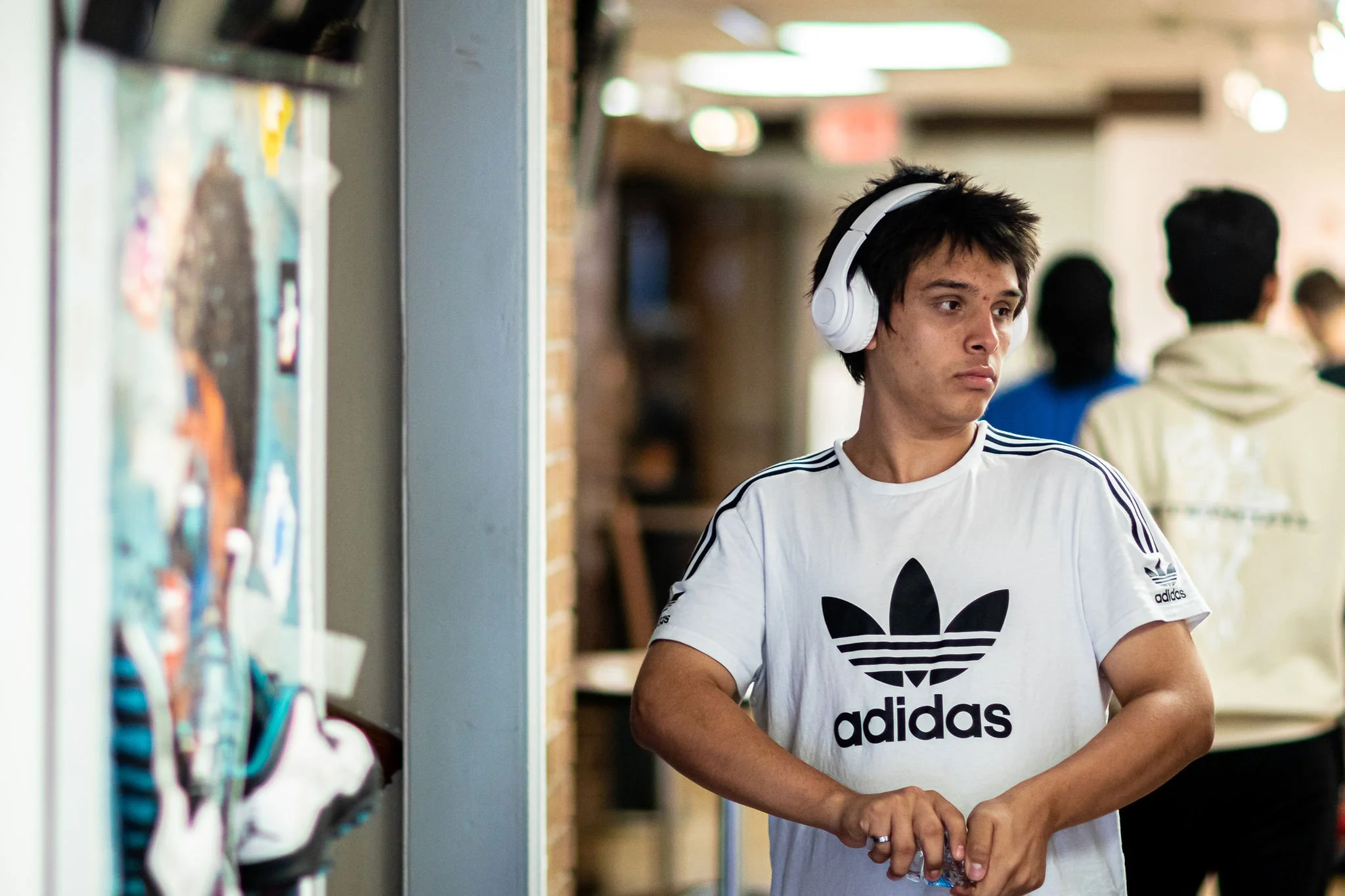 young man looking around at the hallway exhibit.