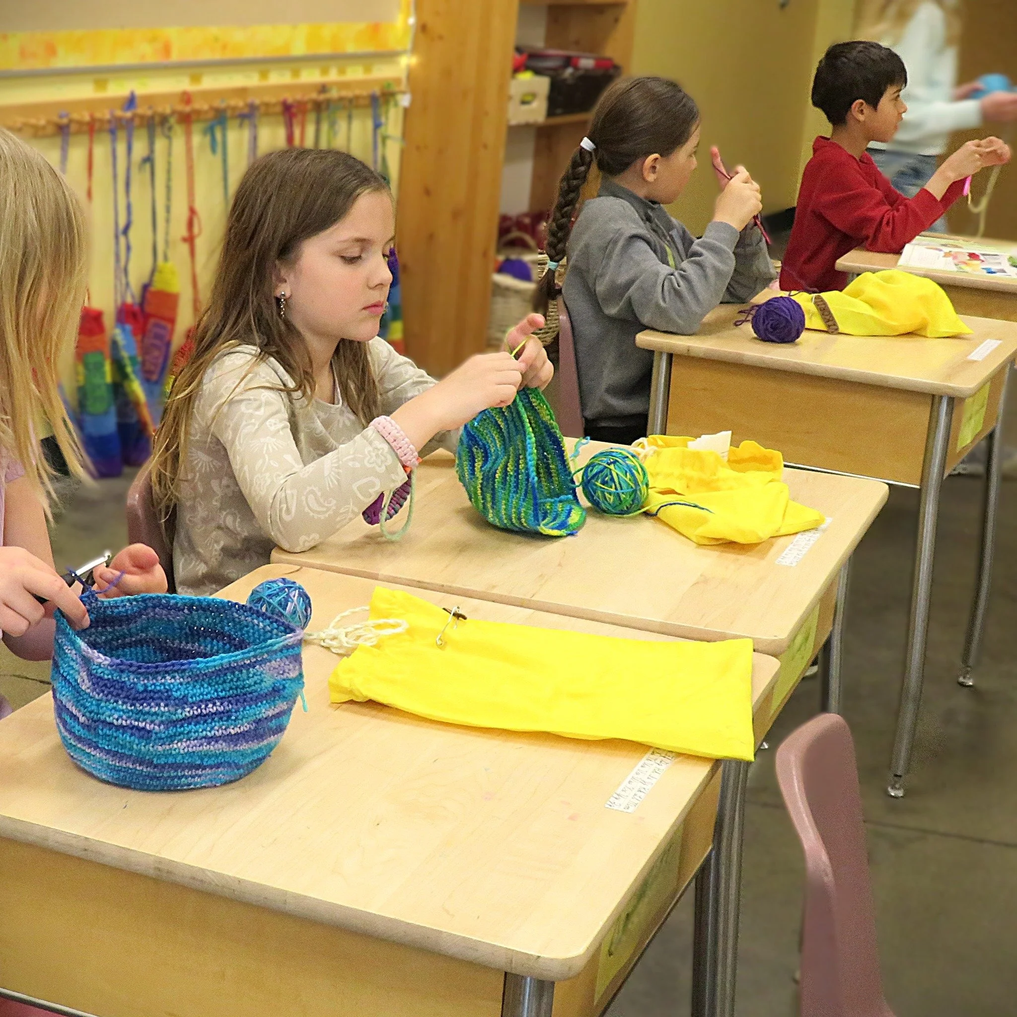 Our third grade students are mastering the art of the custom hat, beginning by hand-dyeing their own vibrant yarn before trading knitting needles for crochet hooks. This classic handwork project builds incredible focus and fine motor skills, resultin