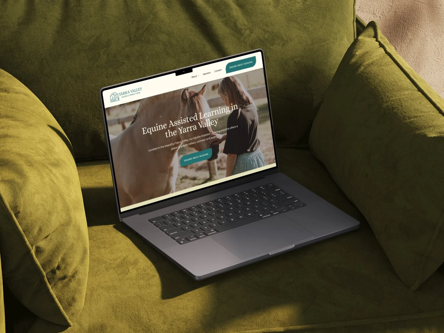 An image of a laptop on a green velvet arm chair showing the yarra valley equine connections website