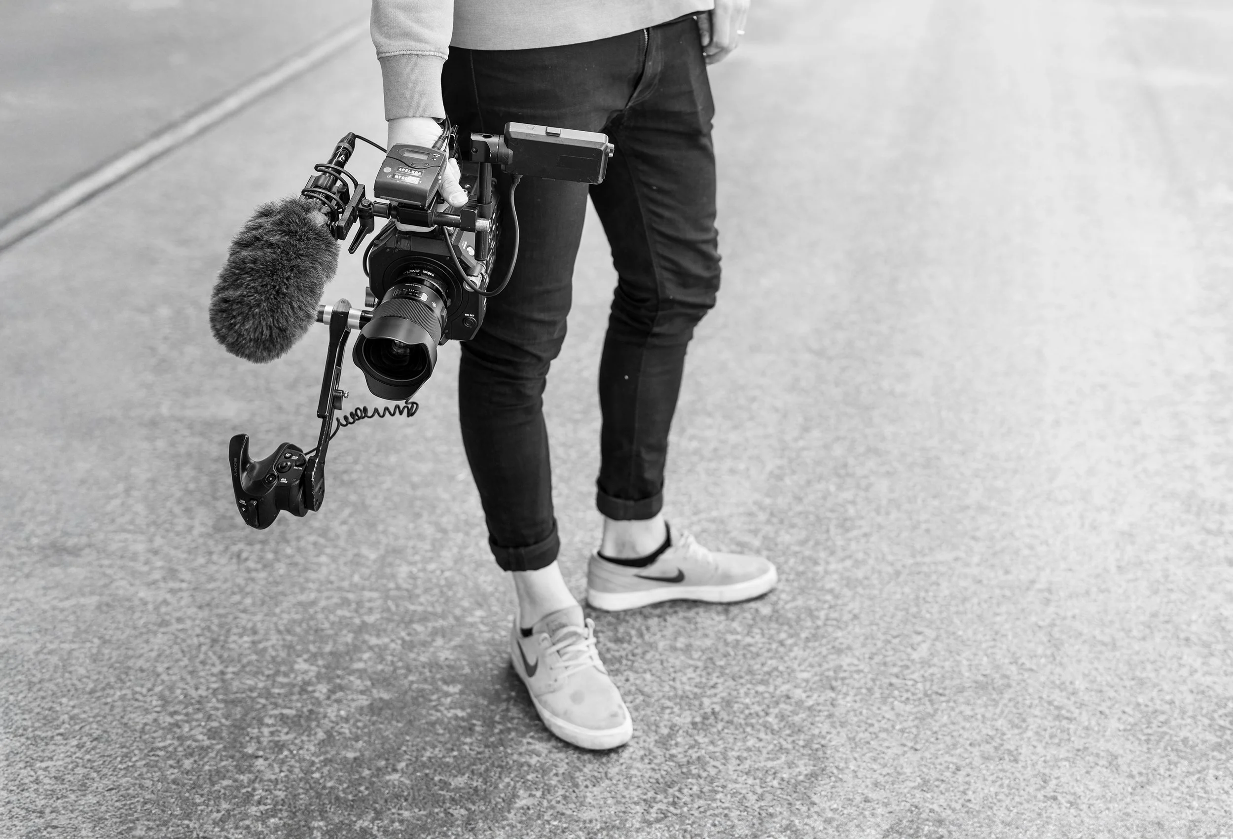 Two people are out in the woods producing film.