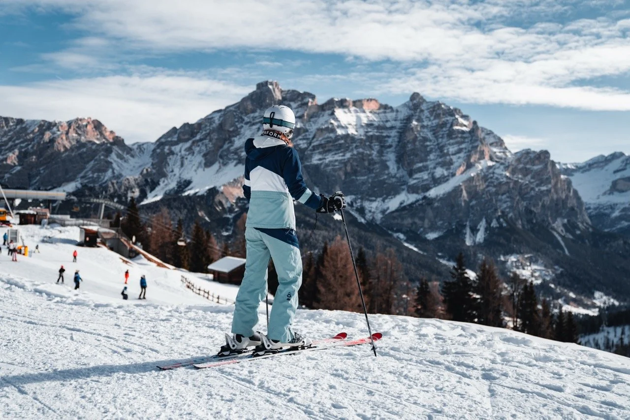 skiier overlooking the mountains before a descent, in winter