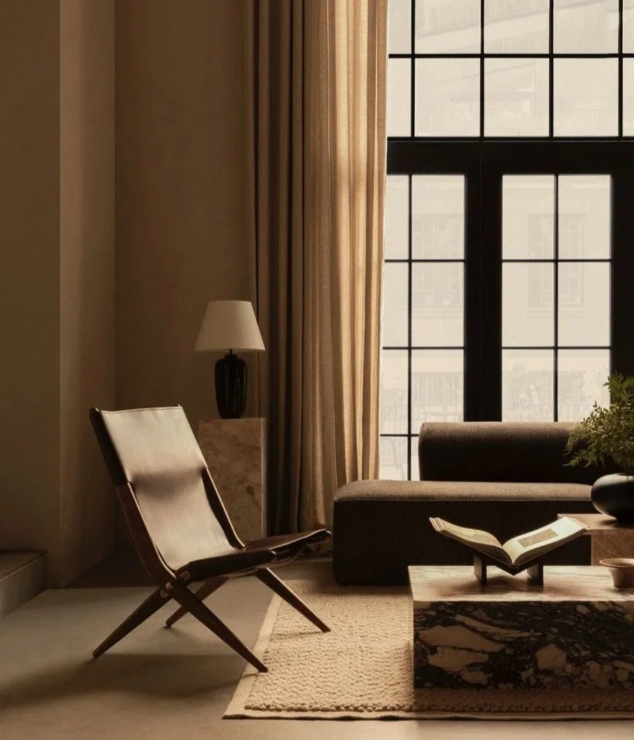 luxury setup in a hotel space with marble coffee table, leather chair and Scandinavian design