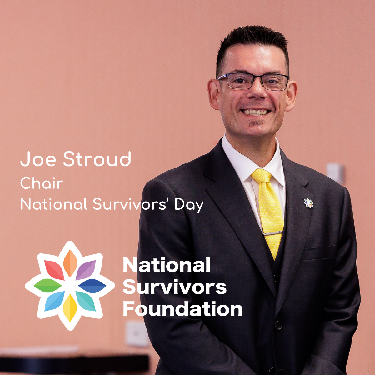 Joe smiles for the camera, he has black hair.