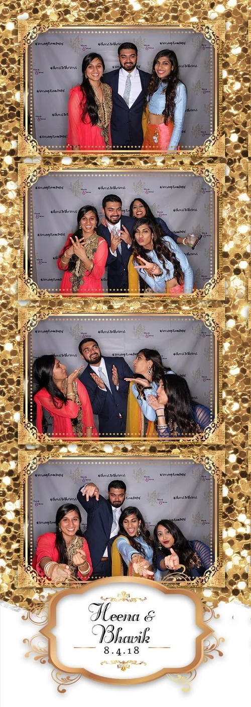 Wedding guests posing with a gold-framed print design