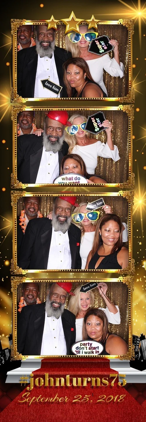 Adults celebrating a 75th birthday with props