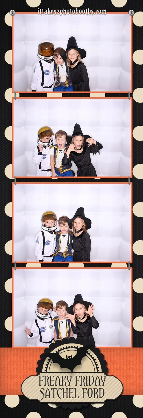 Kids in Halloween costumes posing in the booth