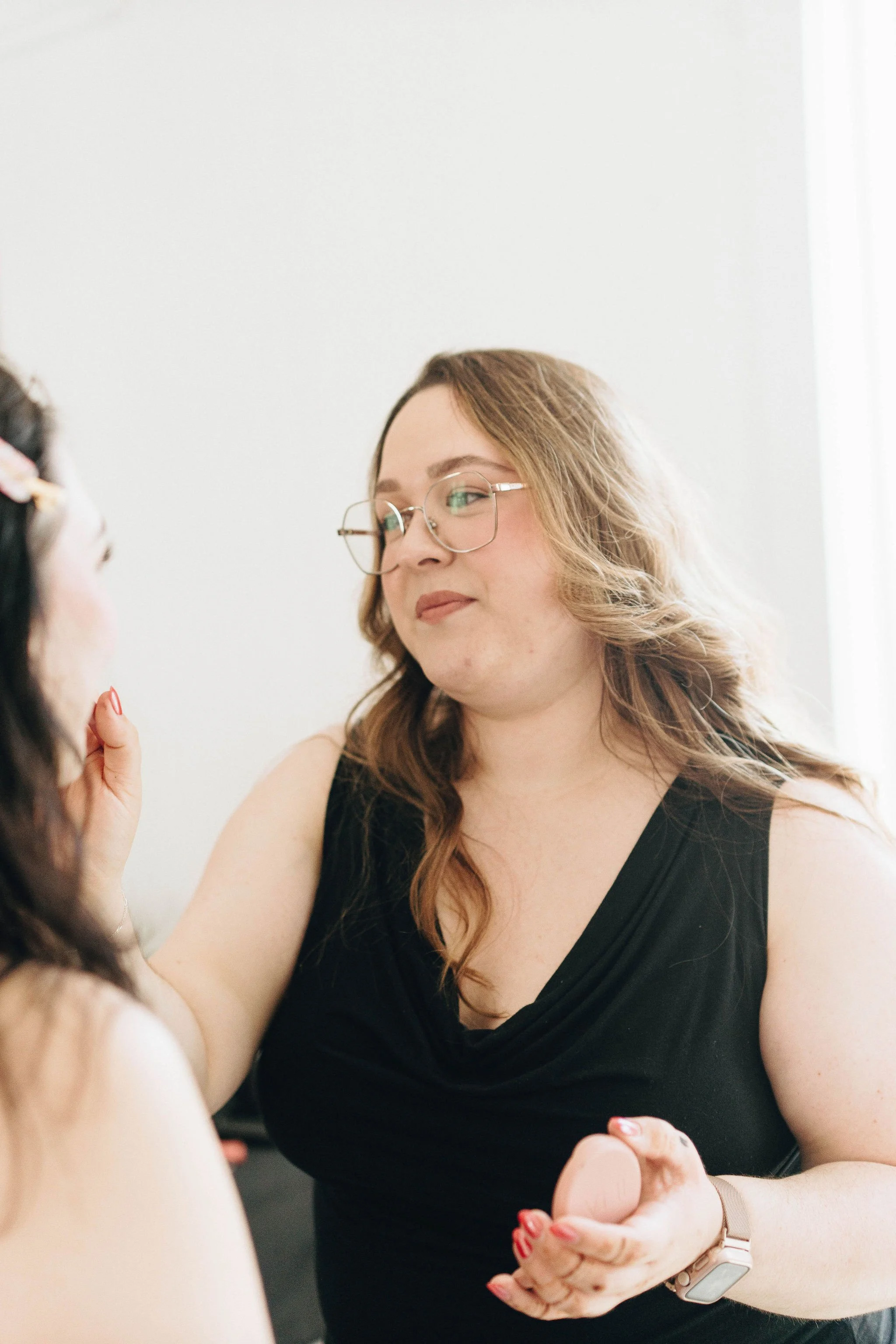 woman applying makeup to model during her business's brand shoot at The White Room in Lancaster City
