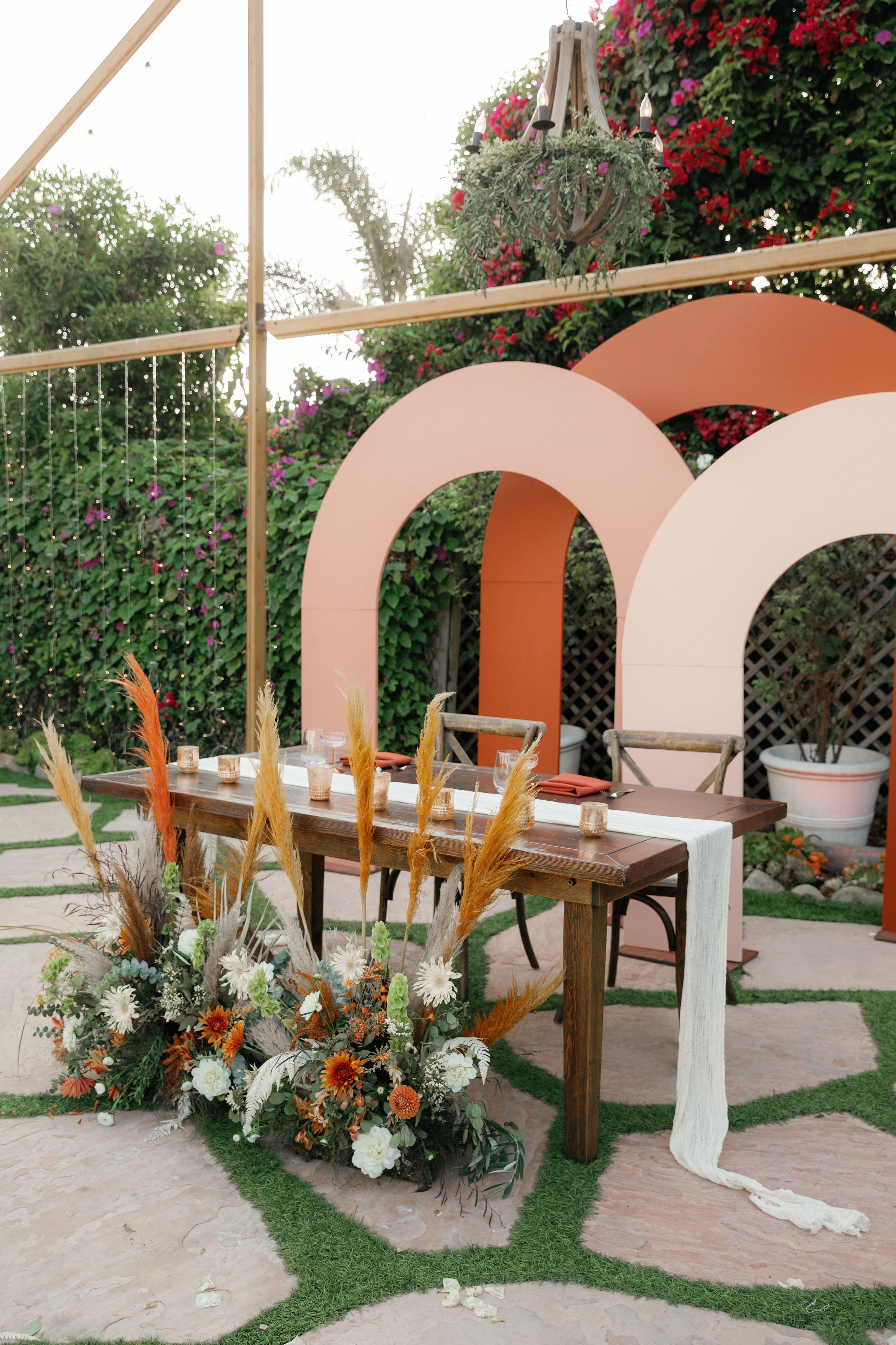 www.santabarbarawedding.com | Rincon Beach Club | Rachel Wakefield | PacWest Blooms | Backdrop Boutique SB | Sweetheart Table in Front of Modern Backdrop 