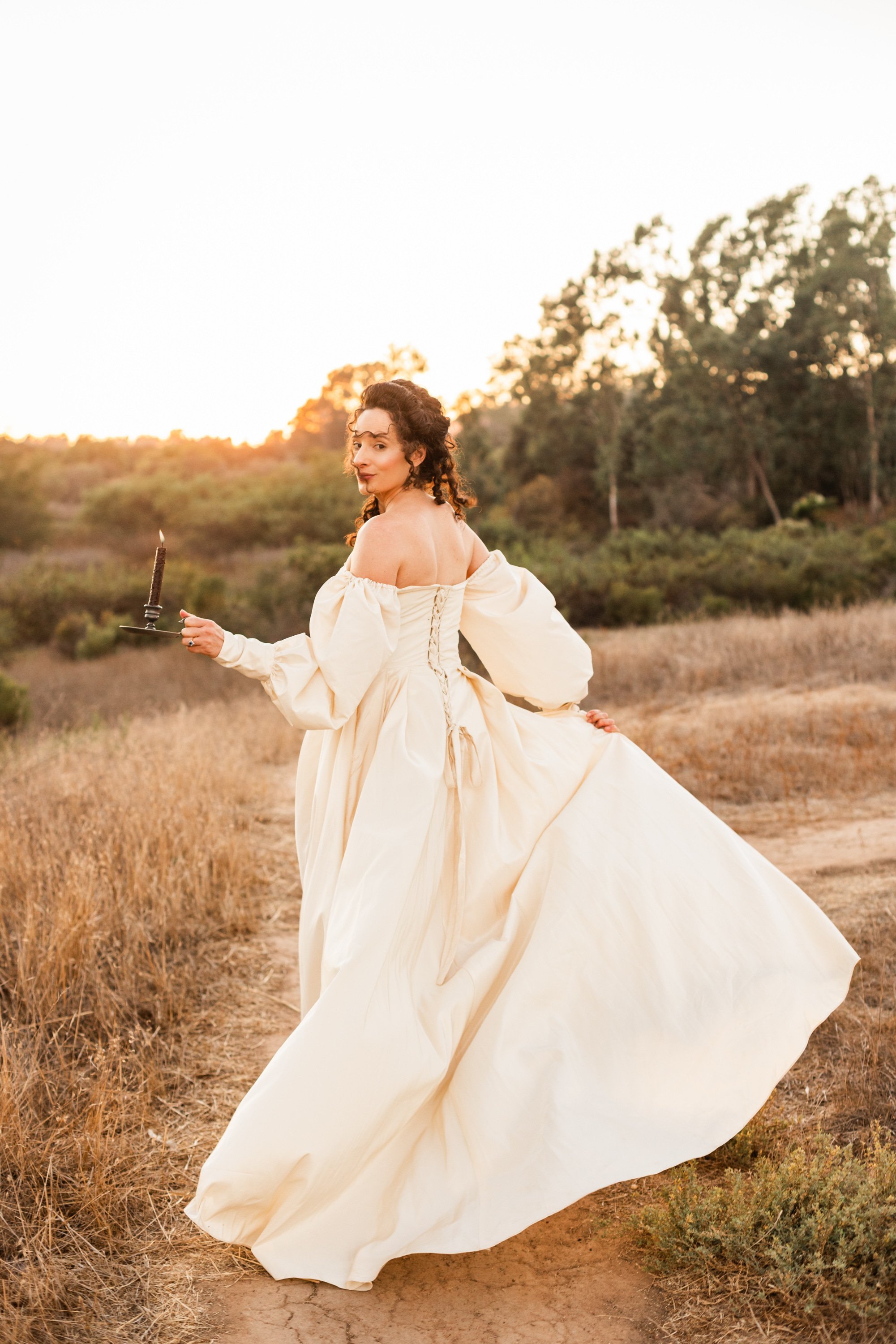 www.santabarbarawedding.com | Veils &amp; Tails | Kelly Rose | Dalliance Gown Rentals | Alpha Thrift | Model Running the Opposite Direction Holding a Candle