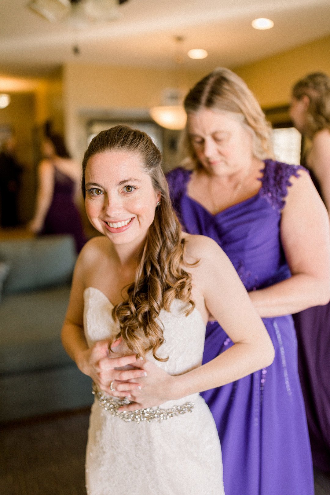 www.santabarbarawedding.com | Three16 Photography | Embassy Suites by Mandalay Beach Resort | One Sweet Day | Kay’s Bridal | Mane Tribe Salon | Katherine Fleming | Bride Putting on Dress