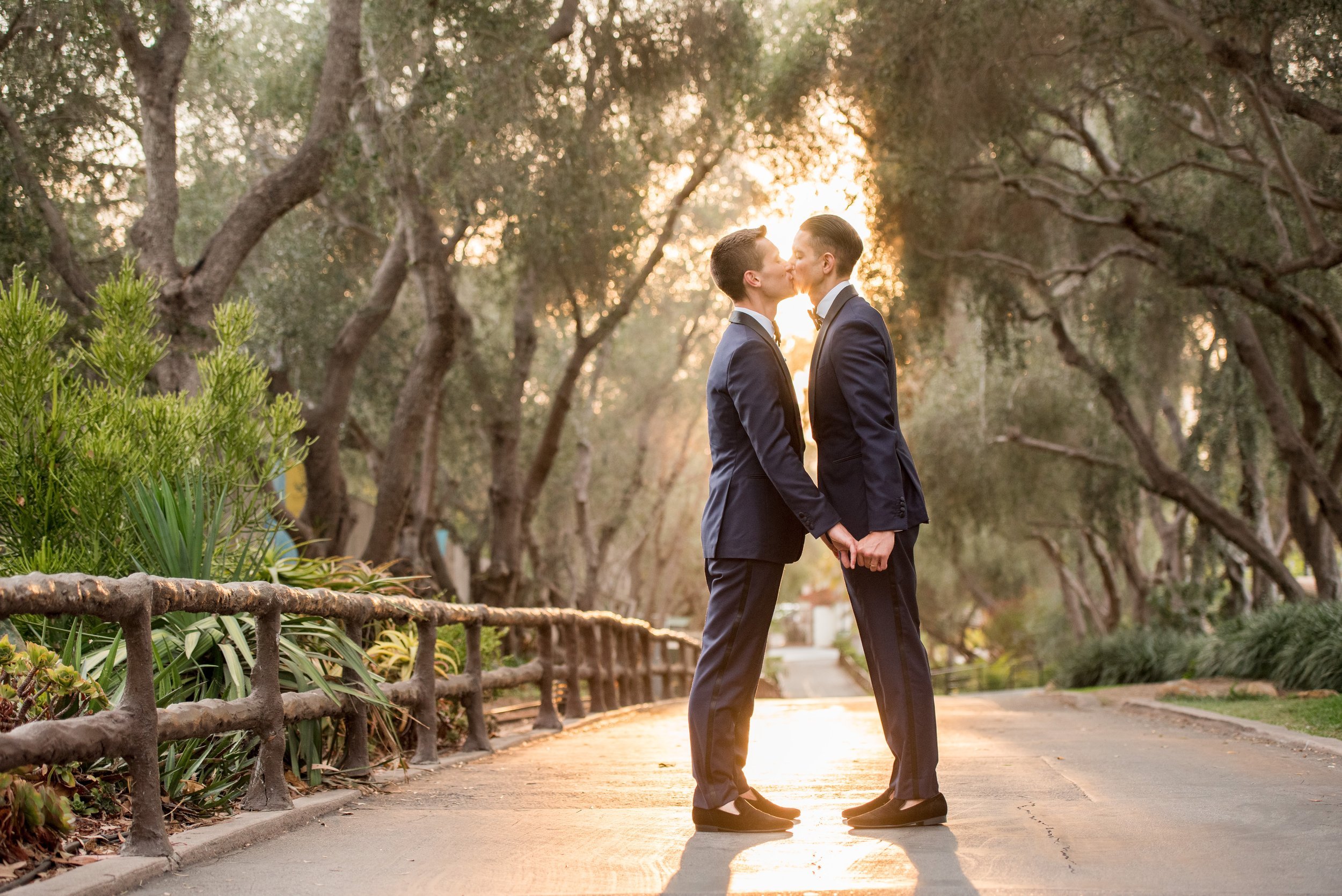 www.santabarbarawedding.com | ByCherry Photography | Santa Barbara Zoo | Events by Rincon | Cartier | Grooms Kissing on the Zoo Walkway
